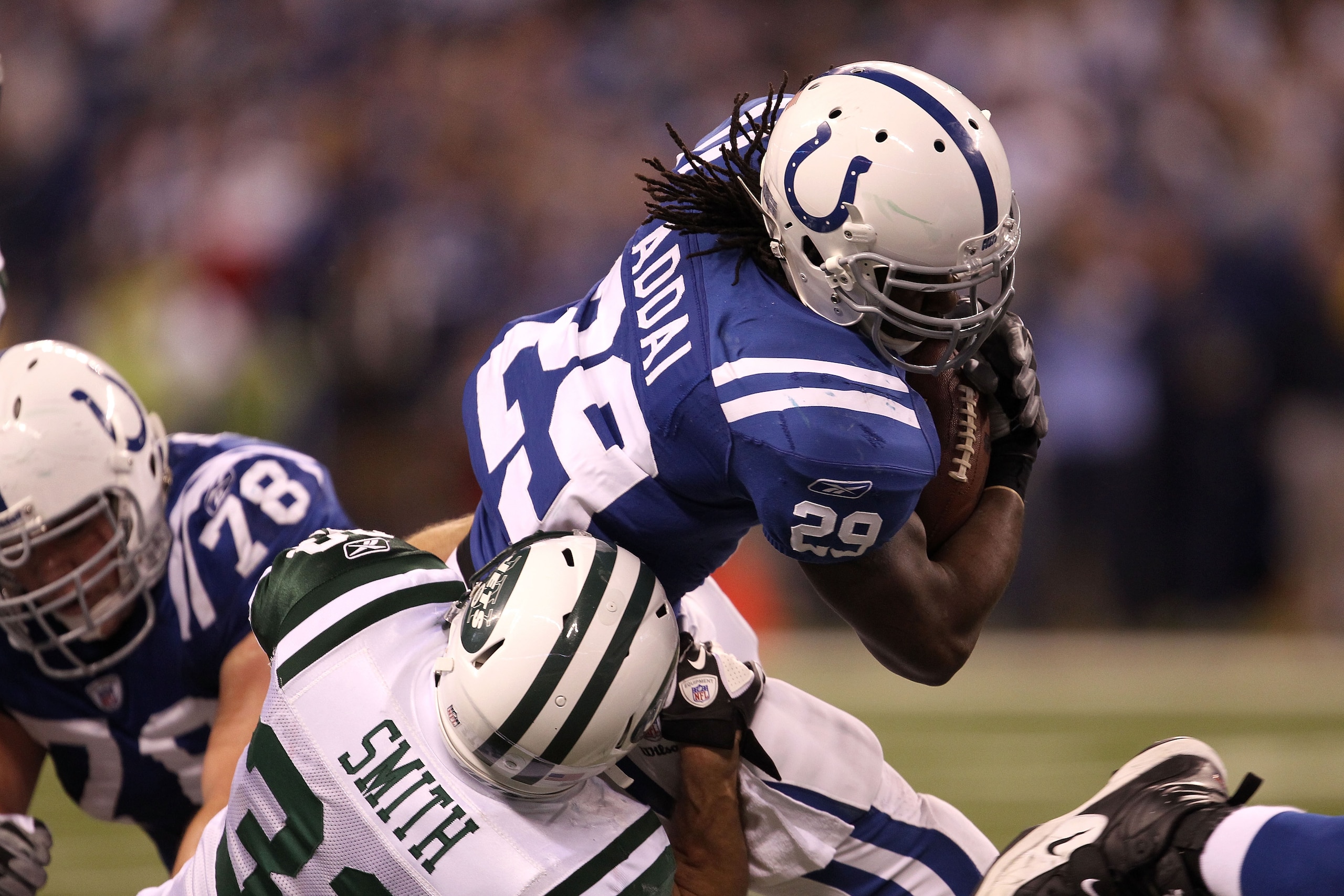 INDIANAPOLIS, IN - JANUARY 08: Joseph Addai #29 of the Indianapolis Colts runs the ball against Eric Smith #33 of the New York Jets during their 2011 AFC wild card playoff game at Lucas Oil Stadium on January 8, 2011 in Indianapolis, Indiana. The Jets wo INDIANAPOLIS, IN - JANUARY 08: Joseph Addai #29 of the Indianapolis Colts runs the ball against Eric Smith #33 of the New York Jets during their 2011 AFC wild card playoff game at Lucas Oil Stadium on January 8, 2011 in Indianapolis, Indiana. The Jets wo
