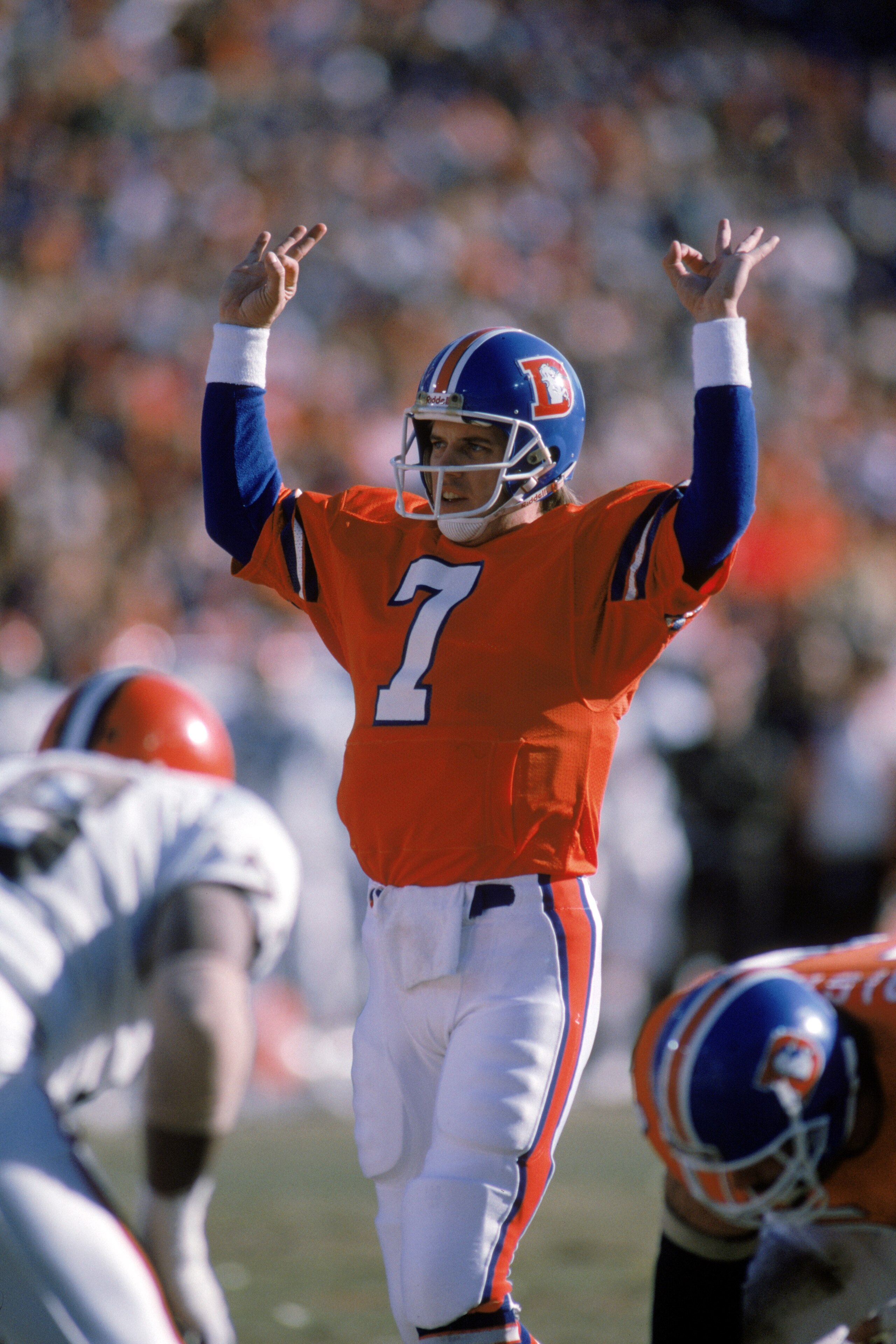 DENVER - JANUARY 17:  Quarterback John Elway #7 of the Denver Broncos calls a play at the line of scrimmage during the 1987 AFC Championship game against the Cleveland Browns at Mile High Stadium on January 17, 1988 in Denver, Colorado.  The Broncos won 3