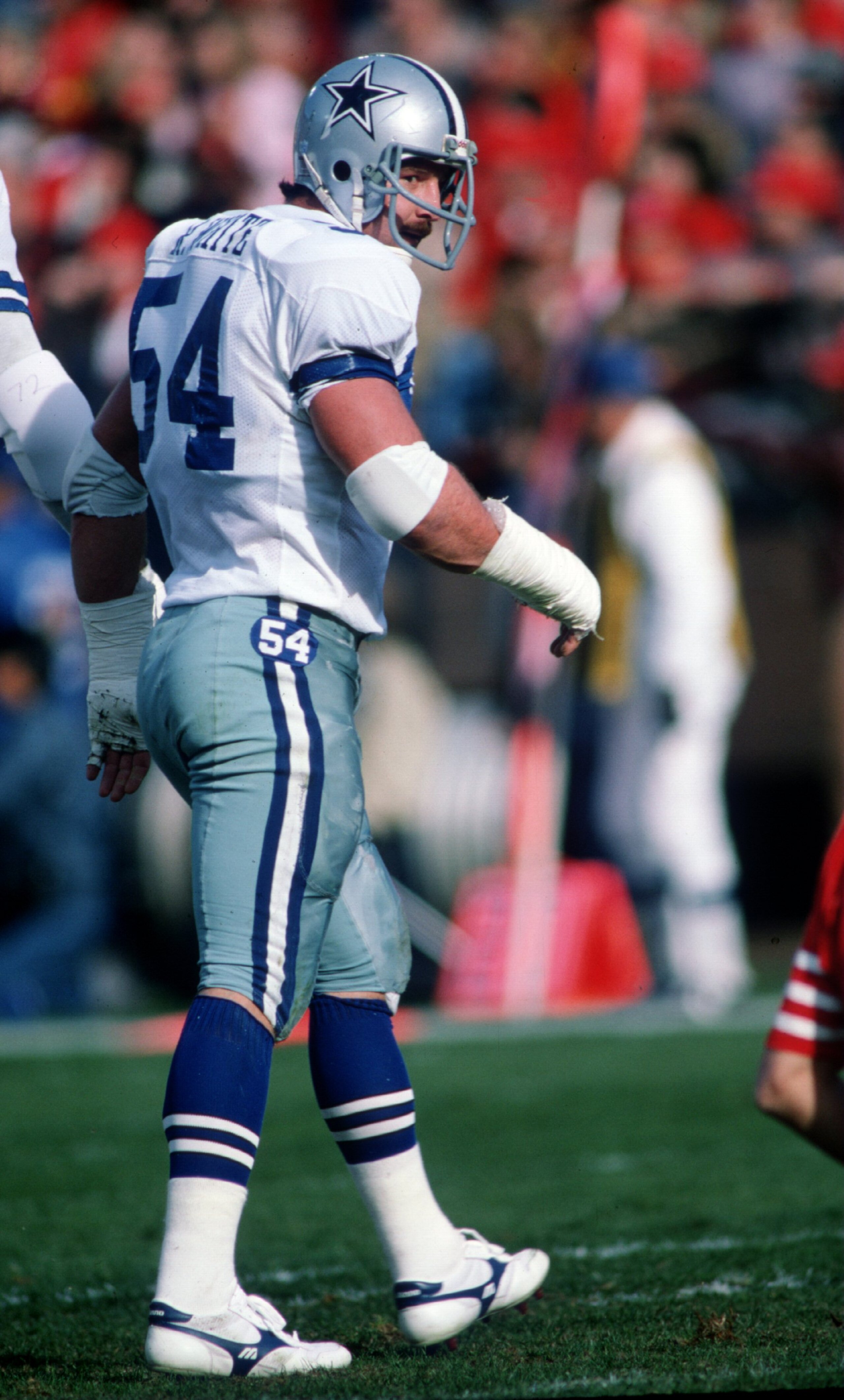 Randy White of the Dallas Cowboys walks on the field during a 1985 game against the San Francisco 49ers.