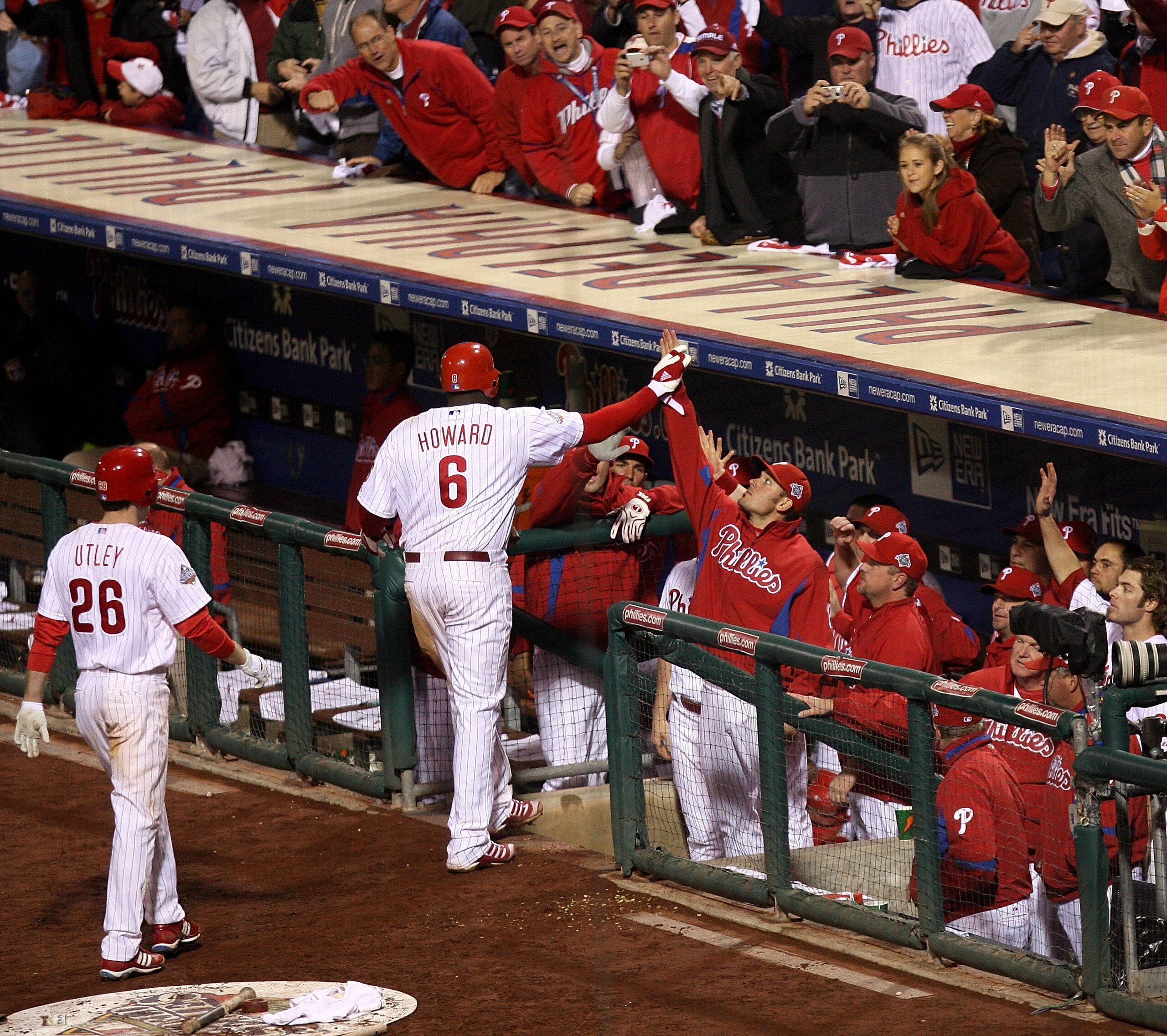 PHILADELPHIA - OCTOBER 26:  Ryan Howard #6 of the Philadelphia Phillies celebrates with teammates in the dugout after he hit a 2-run home run which also scored Chase Utley #26 in the bottom of the eighth inning against the Tampa Bay Rays looks on during g