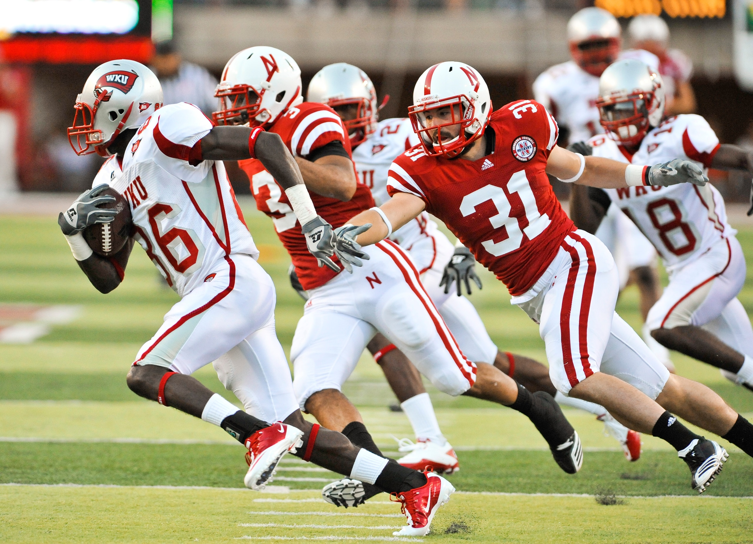 LINCOLN, NE - SEPTEMBER 04: Willie McNeal of the Western Kentucky Hilltoppers attempts to out run Jase Dean #31 of the Nebraska Cornhuskers after a mishandled punt during first half action of their game at Memorial Stadium on September 4, 2010 in Lincoln,