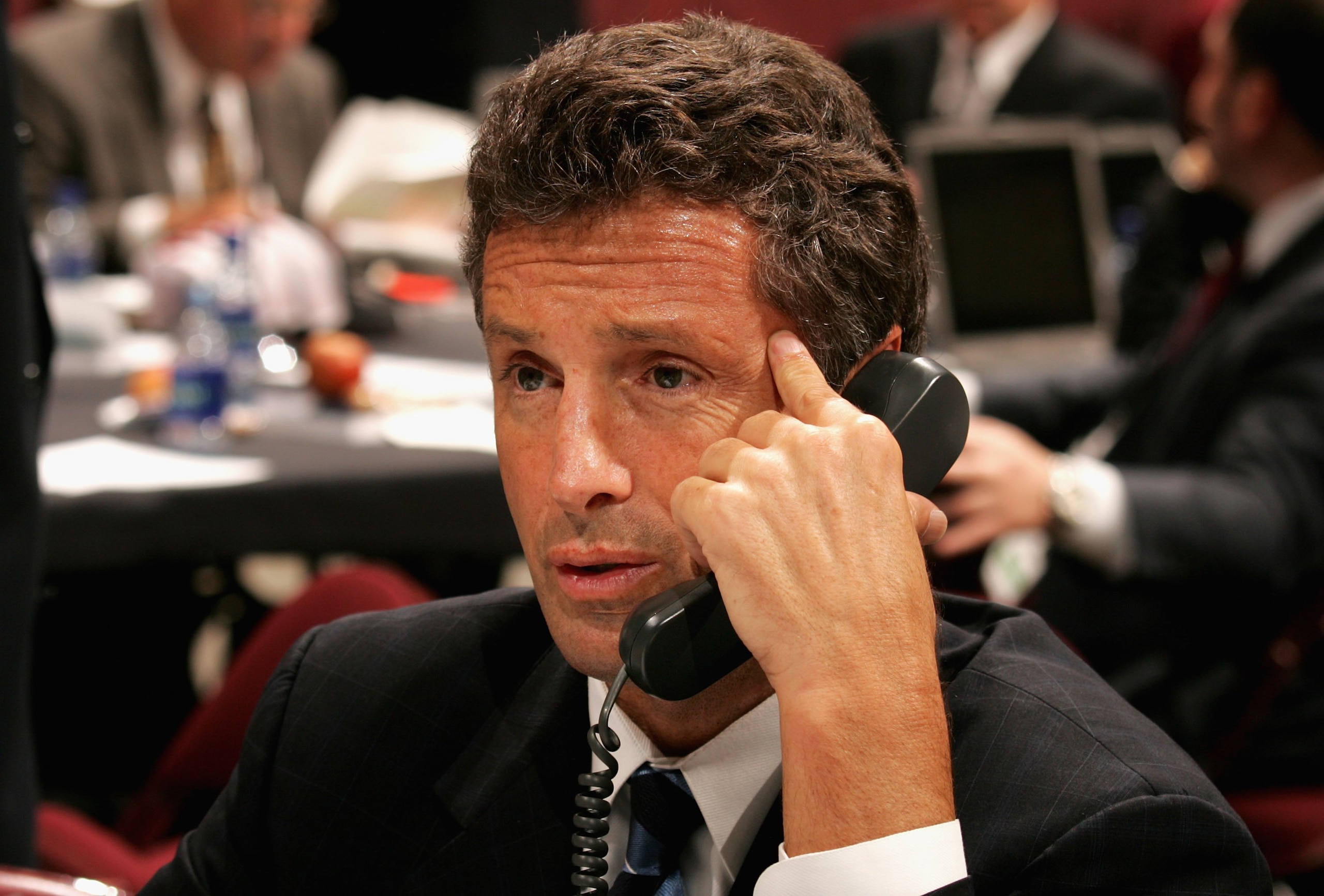 VANCOUVER, BC - JUNE 24:  General manager Doug Wilson of the San Jose Sharks talks on the phone during the 2006 NHL Draft held at General Motors Place on June 24, 2006 in Vancouver, Canada.   (Photo by Bruce Bennett/Getty Images)
