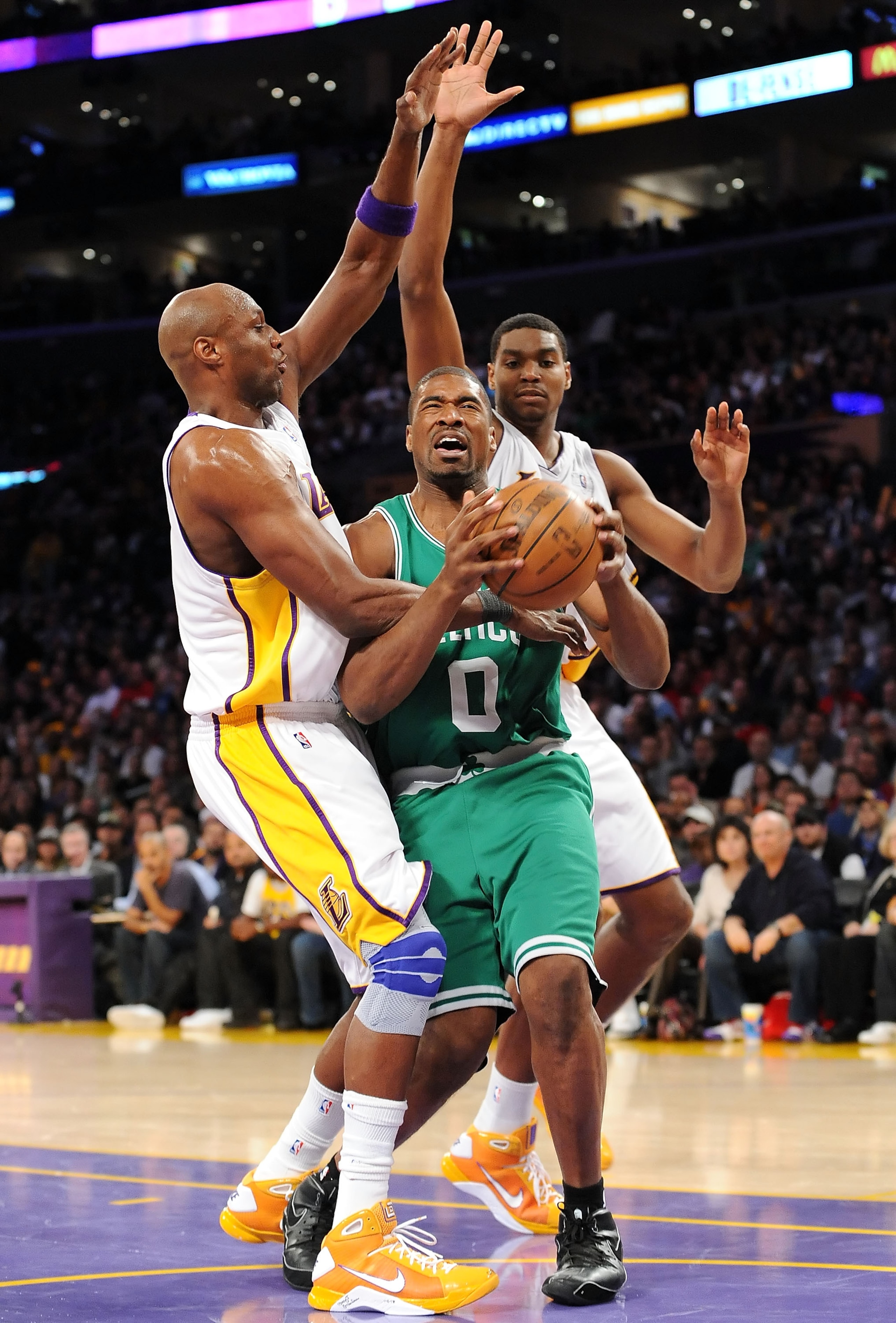 LOS ANGELES, CA - DECEMBER 25:   Lamar Odom #7 and Andrew Bynum #17 of the Los Angeles Lakers put the pressure on Leon Powe #0 of the Boston Celtics at Staples Center on December 25, 2008 in Los Angeles, California.  NOTE TO USER: User expressly acknowled