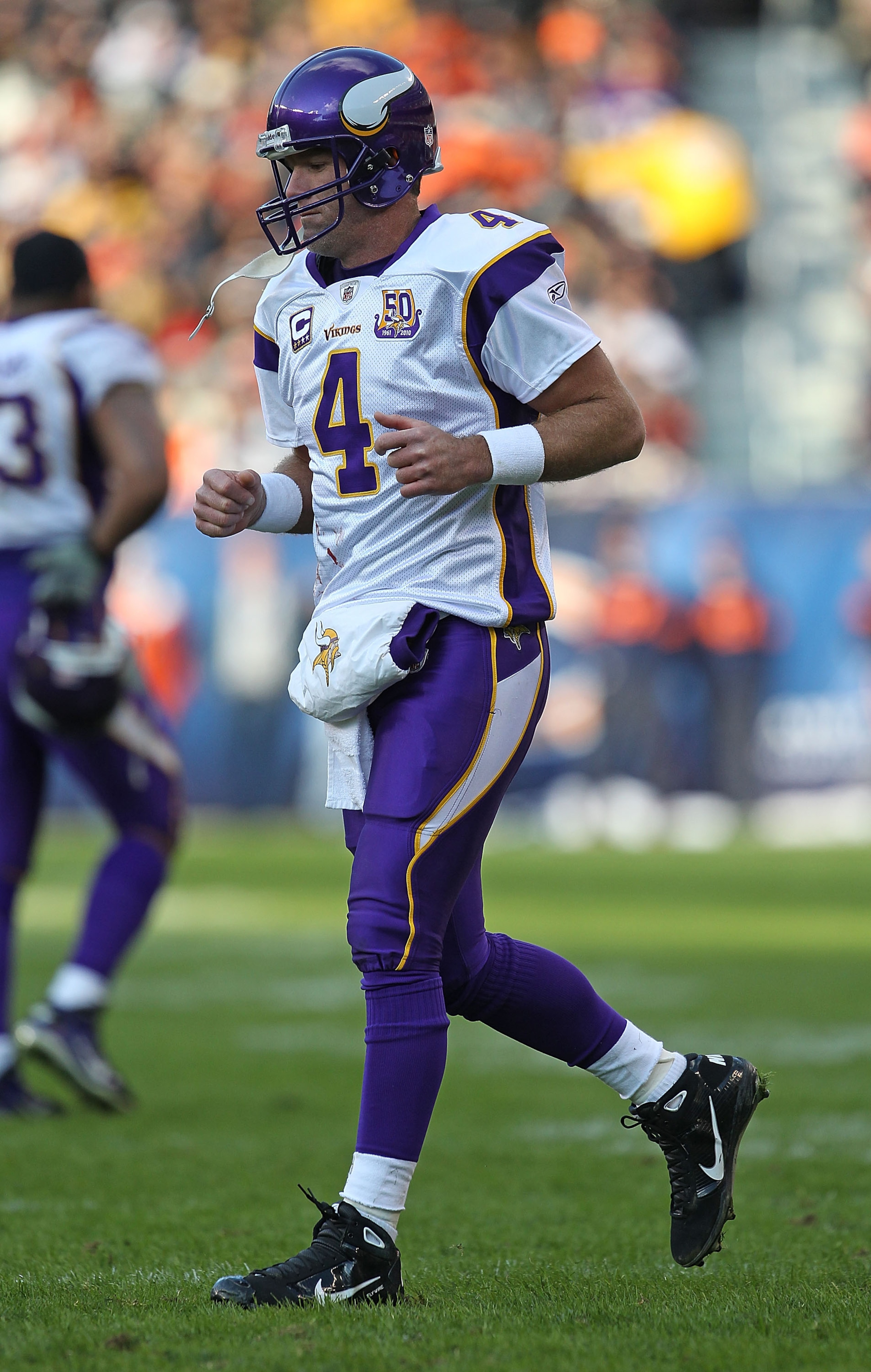 CHICAGO - NOVEMBER 14: Brett Favre #4 of the Minnesota Vikings walks back to the field of play from the sidelines during a game against the Chicago Bears at Soldier Field on November 14, 2010 in Chicago, Illinois. The Bears defeated the Vikings 27-13. (Ph CHICAGO - NOVEMBER 14: Brett Favre #4 of the Minnesota Vikings walks back to the field of play from the sidelines during a game against the Chicago Bears at Soldier Field on November 14, 2010 in Chicago, Illinois. The Bears defeated the Vikings 27-13. (Ph