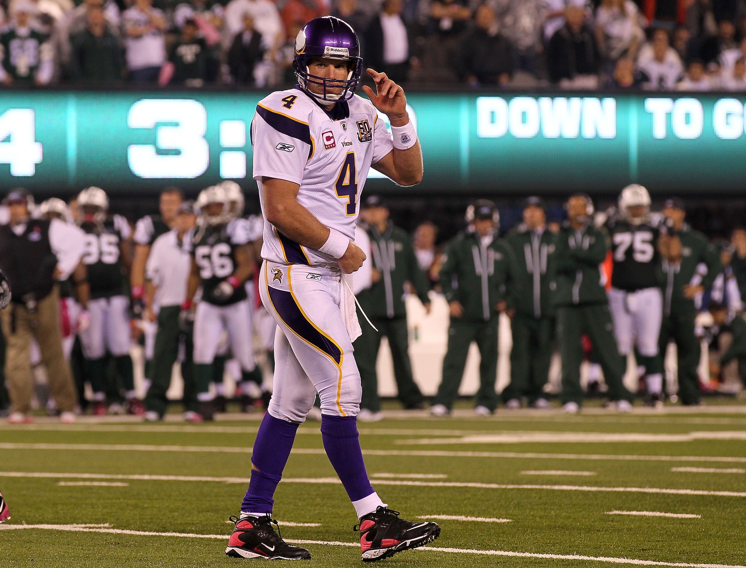 EAST RUTHERFORD, NJ - OCTOBER 11: Quarterback Brett Favre #4 of the Minnesota Vikings holds his right arm against his body as he walks to the sideline late in the second half against the New York Jets at New Meadowlands Stadium on October 11, 2010 in Eas EAST RUTHERFORD, NJ - OCTOBER 11: Quarterback Brett Favre #4 of the Minnesota Vikings holds his right arm against his body as he walks to the sideline late in the second half against the New York Jets at New Meadowlands Stadium on October 11, 2010 in Eas