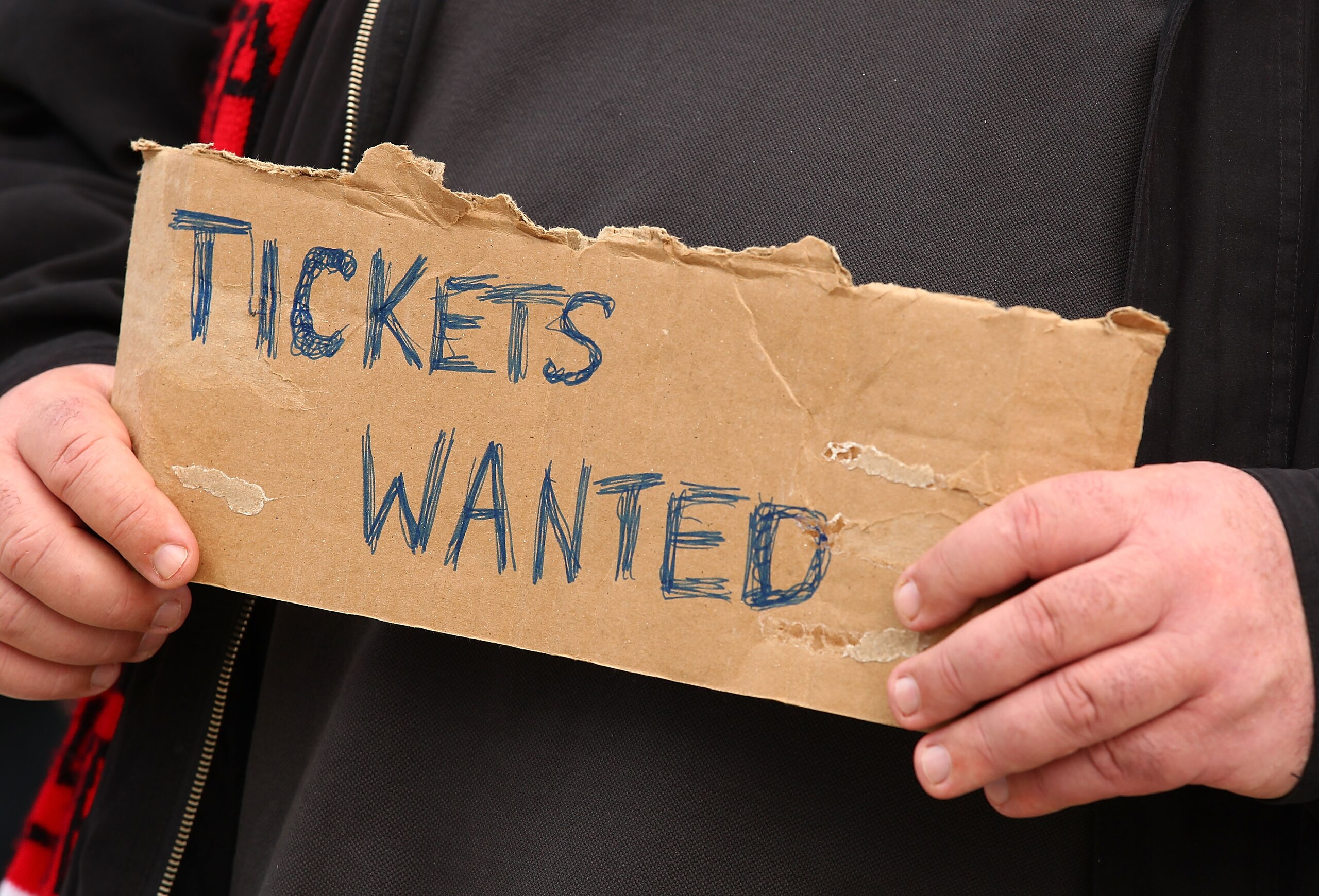 MELBOURNE, AUSTRALIA - SEPTEMBER 25:  A football fan holds a sign requesting match tickets prior to the AFL Grand Final match between the Collingwood Magpies and the St Kilda Saints at Melbourne Cricket Ground on September 25, 2010 in Melbourne, Australia