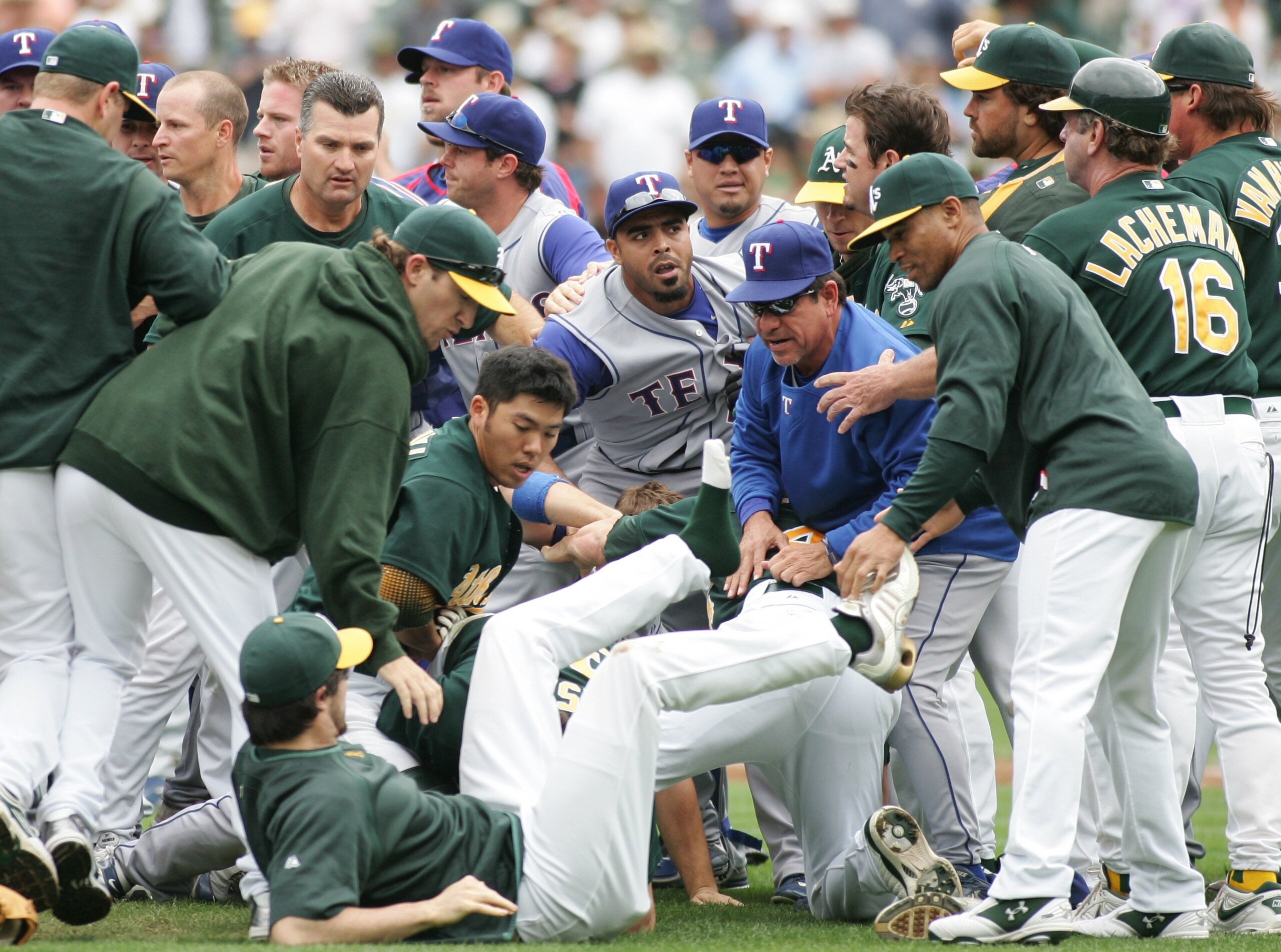 OAKLAND, CA - SEPTEMBER 16:   Dan Haren #15 of the Oakland Athletics falls to the ground during a bench-clearing brawl provoked after Nick Swisher #33 of the Oakland Athletics tackled Vicente Padilla #44 of the Texas Rangers after being hit by a pitch in