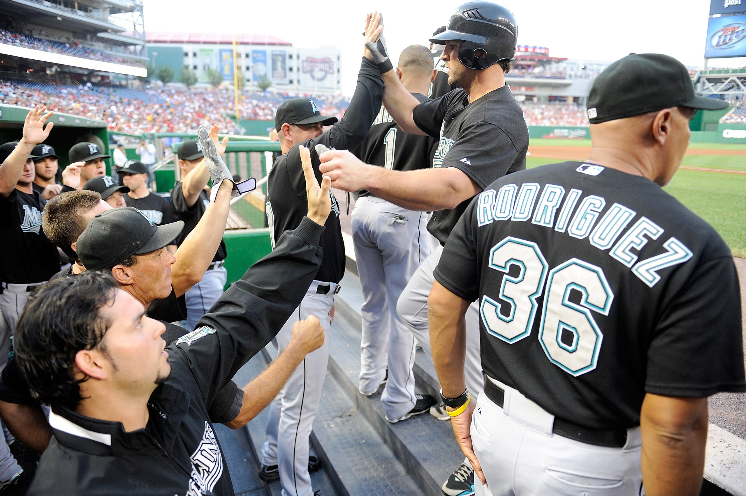 WASHINGTON - AUGUST 10:  Dan Uggla #6 of the Florida Marlins is congratulated by teammates after hitting a home run in the first inning against the Washington Nationals at Nationals Park on August 10, 2010 in Washington, DC.  (Photo by Greg Fiume/Getty Im