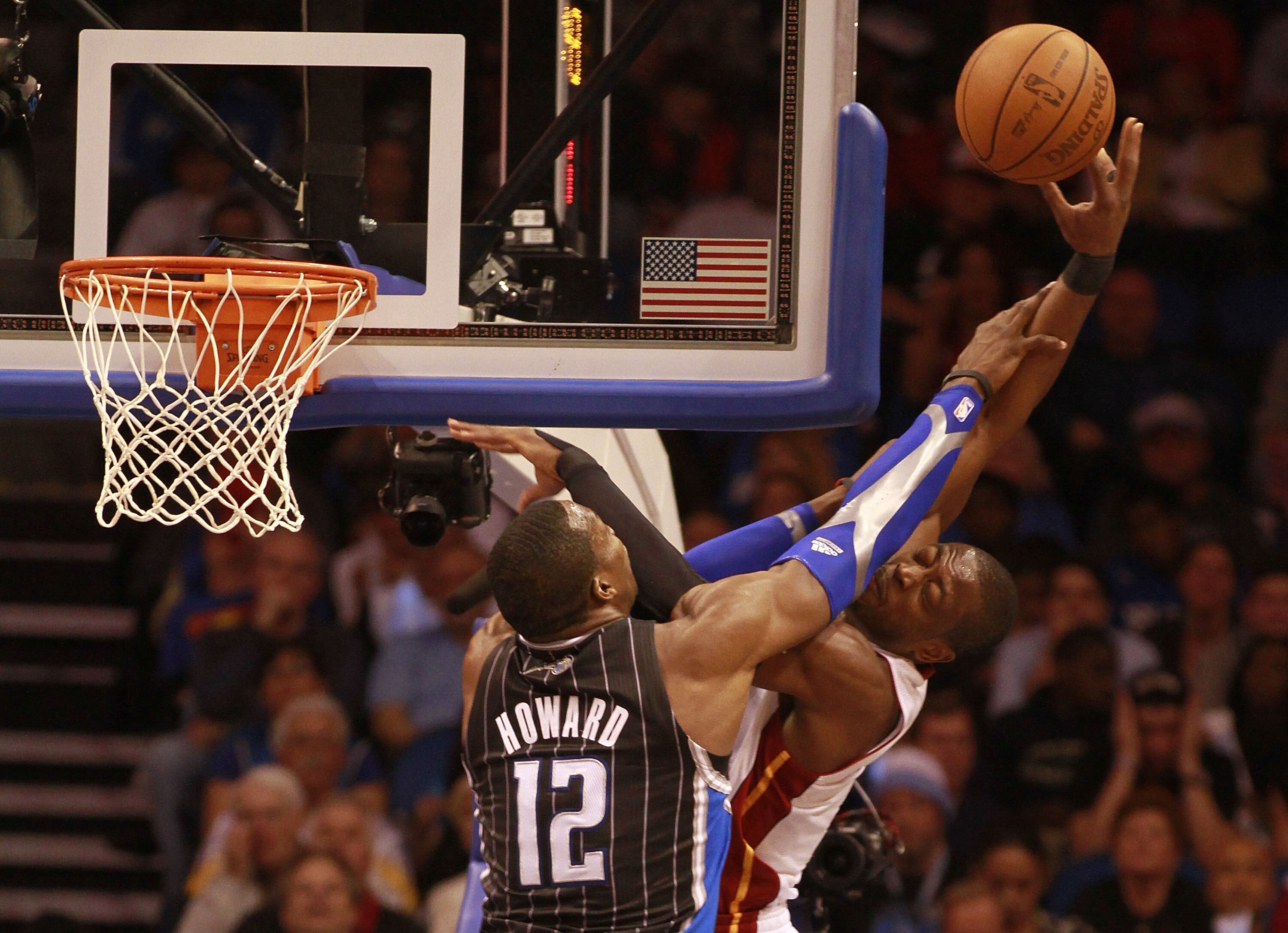 ORLANDO, FL - FEBRUARY 03:  Guard Dwyane Wade #3 of the Miami Heat is fouled by Center Dwight Howard #12 of the Orlando Magic at Amway Arena on February 3, 2011 in Orlando, Florida. NOTE TO USER: User expressly acknowledges and agrees that, by downloading