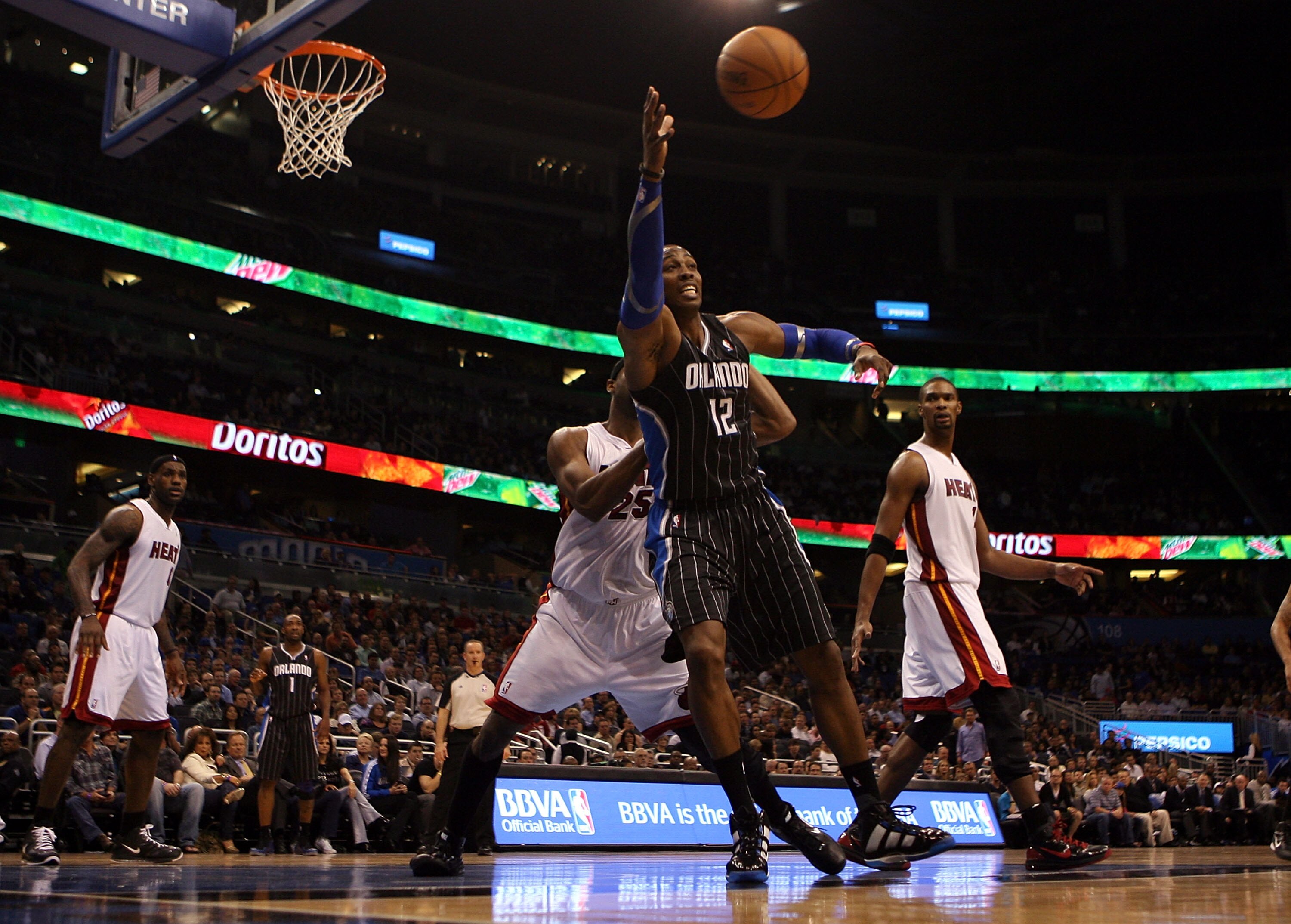 ORLANDO, FL - FEBRUARY 03:  Center Dwight Howard #12 of the Orlando Magic drives against the Miami Heat at Amway Arena on February 3, 2011 in Orlando, Florida. NOTE TO USER: User expressly acknowledges and agrees that, by downloading and or using this pho