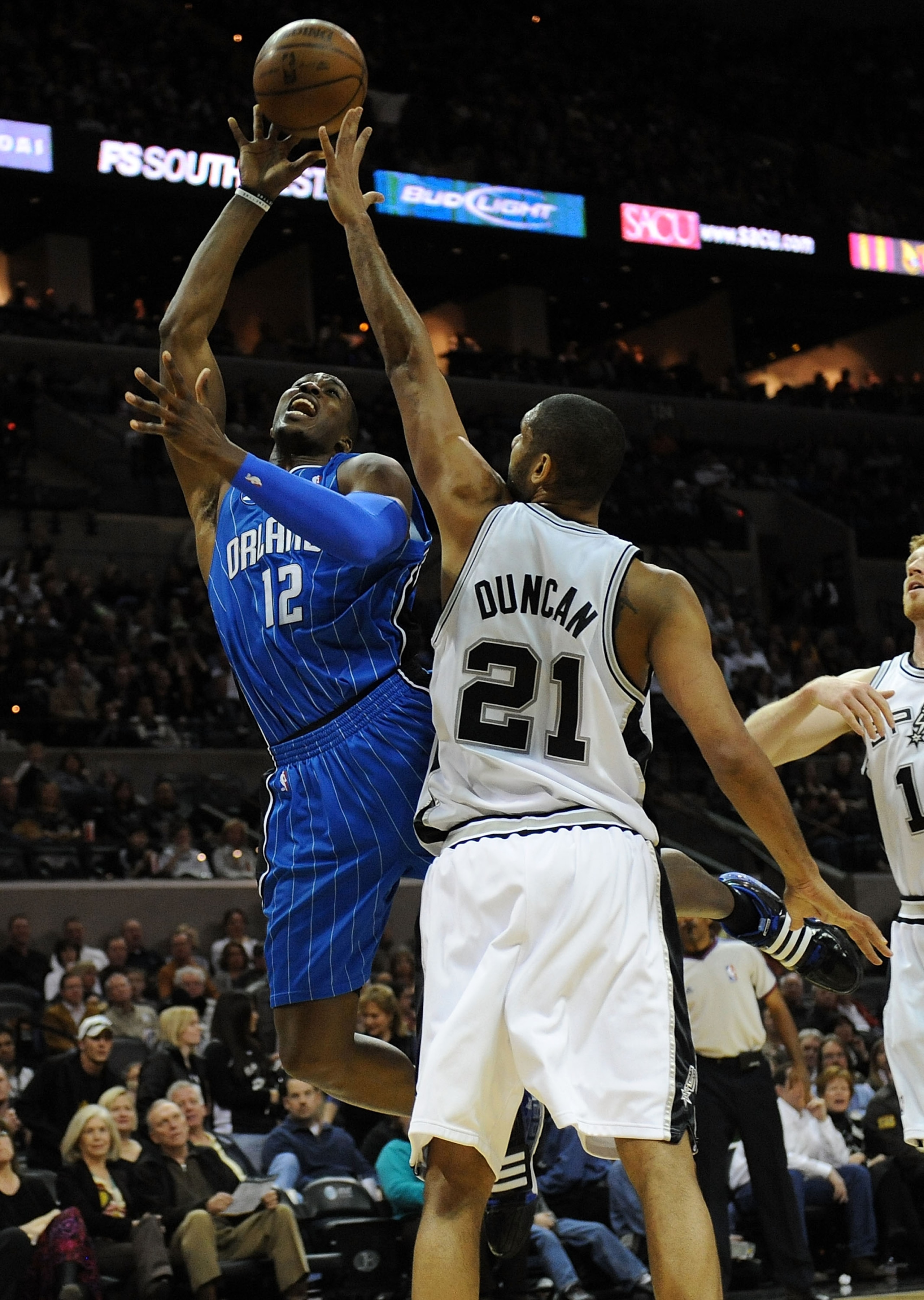 SAN ANTONIO - JANUARY 11:  Center Dwight Howard #12 of the Orlando Magic takes a shot against Tim Duncan #21 of the San Antonio Spurs on January 11, 2009 at AT&T Center in San Antonio, Texas.  NOTE TO USER: User expressly acknowledges and agrees that, by
