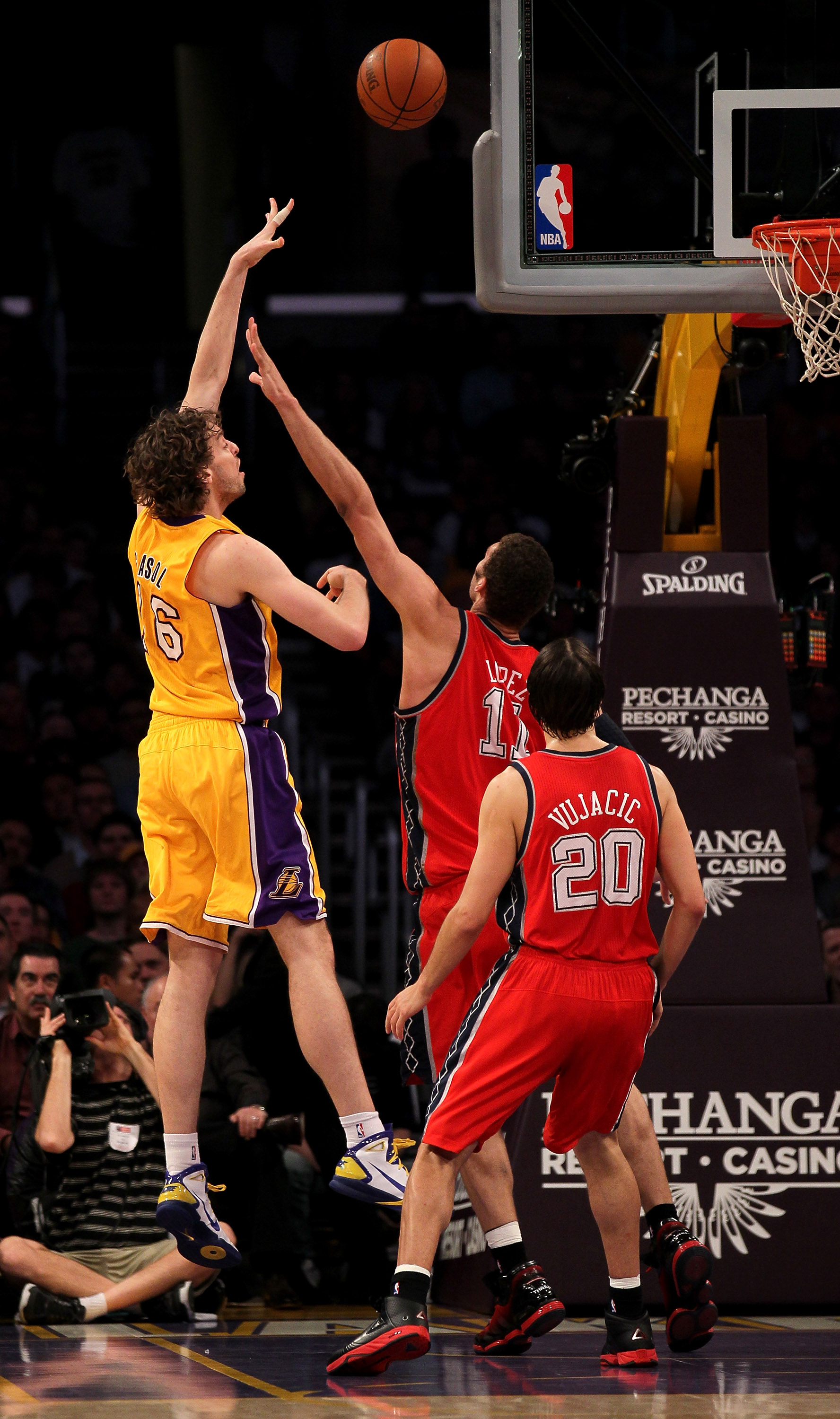 LOS ANGELES, CA - JANUARY 14:  Pau Gasol #16 of the Los Angeles Lakers shoots over Brook Lopez #11 and Sasha Vujacic #20 of the New Jersey Nets at Staples Center on January 14, 2011 in Los Angeles, California. The Lakers won 100-88.  NOTE TO USER: User ex