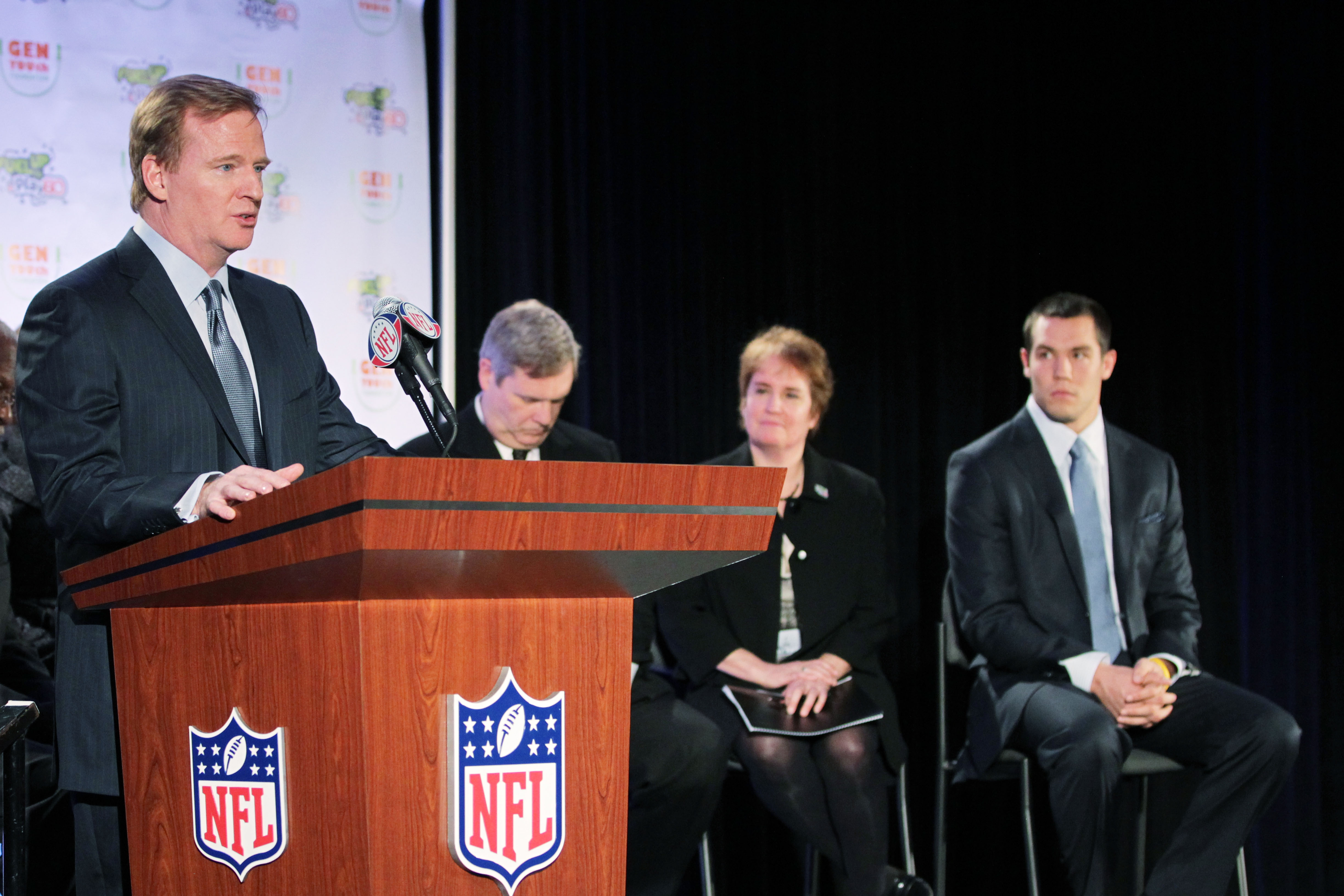 DALLAS, TX - FEBRUARY 04:  (L-R) NFL Commissioner Roger Goodell speaks as U.S. Secretary of Agriculture Tom Vilsack, President of the National Dairy Council Jean Ragalie and Sam Bradford of the St. Louis Rams look on during the launch of the Gen YOUth Fou