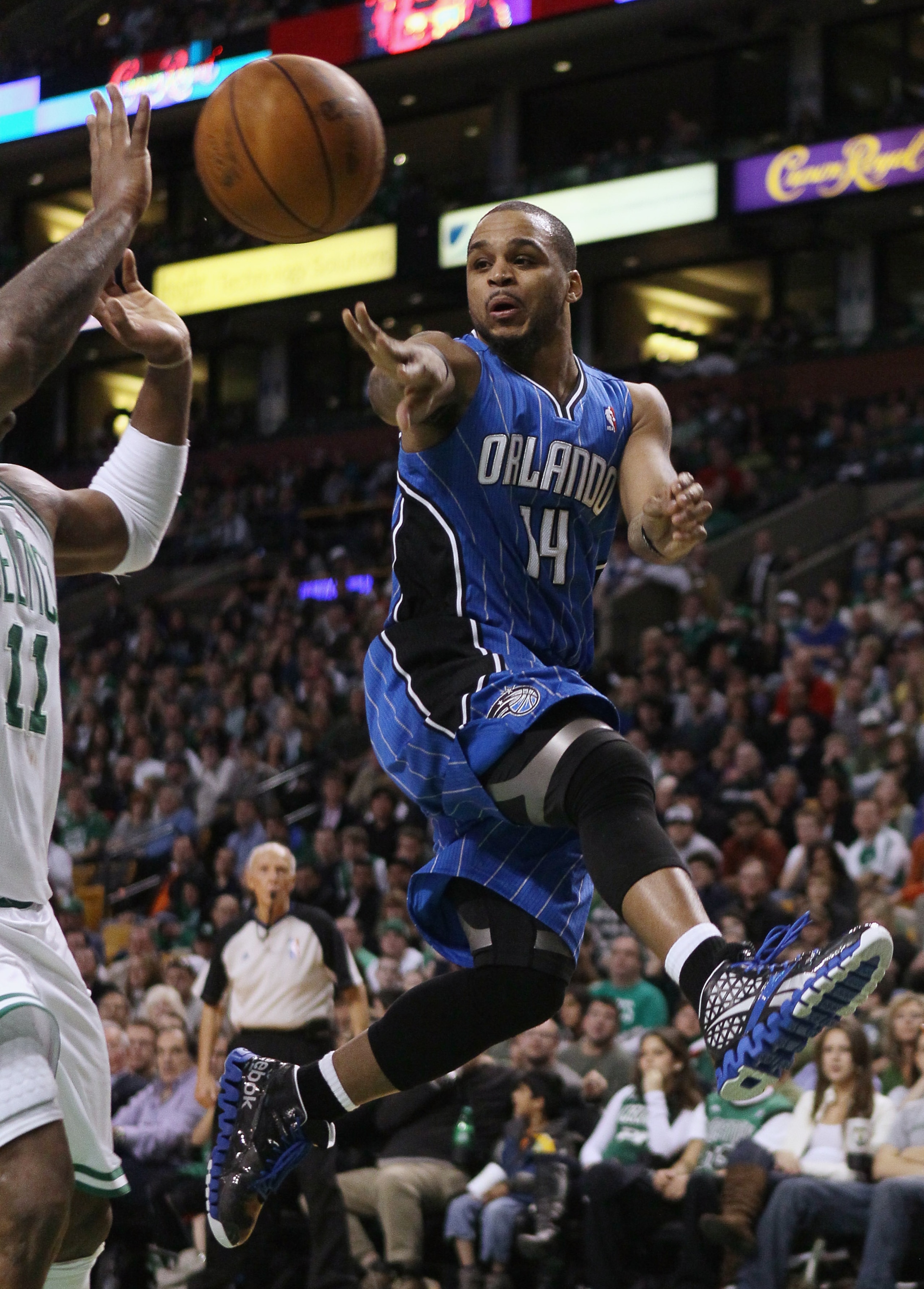 BOSTON, MA - FEBRUARY 06:  Jameer Nelson #14 of the Orlando Magic passes the ball around Glen Davis #11 of the Boston Celtics on February 6, 2011 at the TD Garden in Boston, Massachusetts. The Celtics defeated the Magic 91-80. NOTE TO USER: User expressly