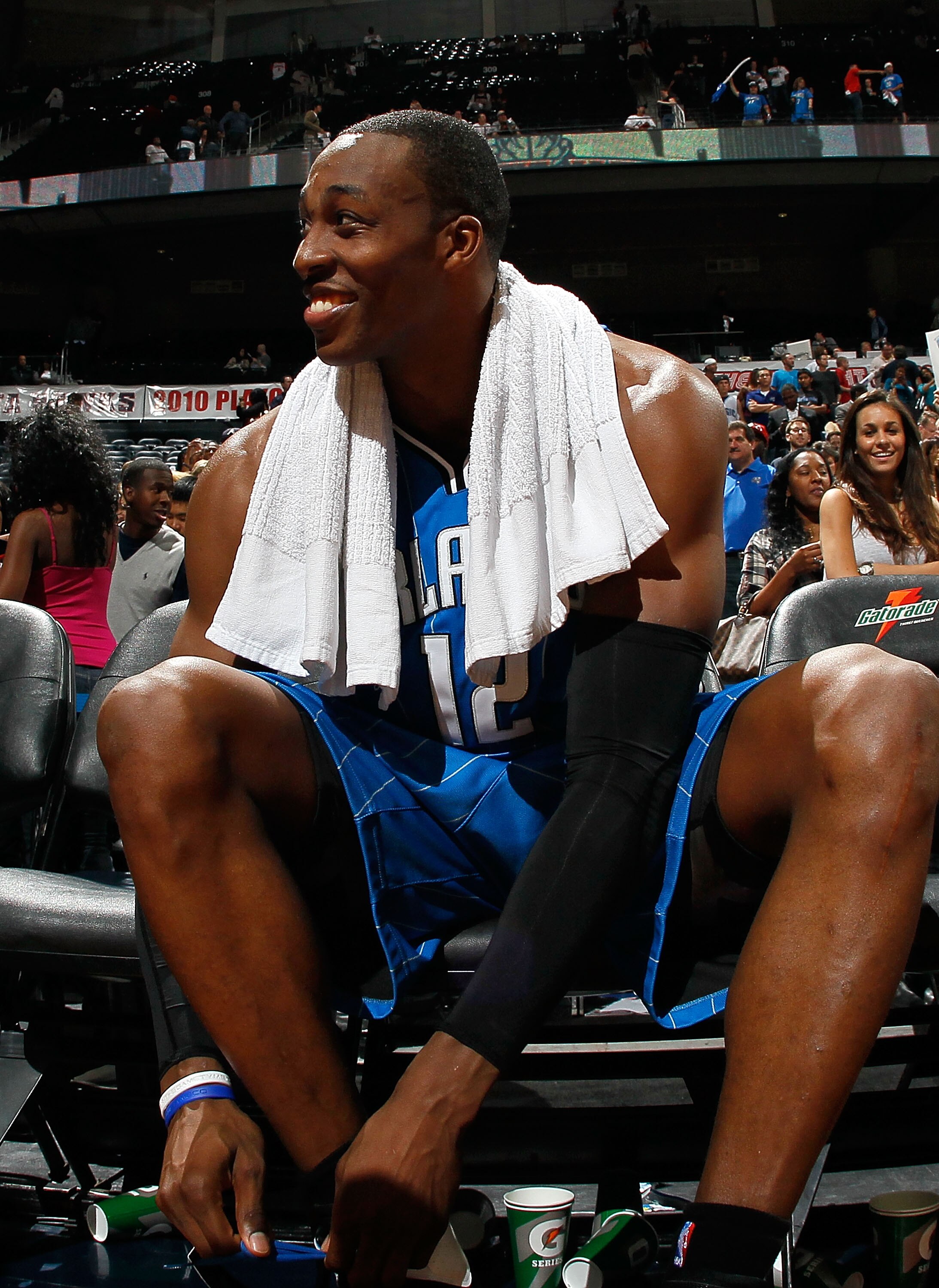 ATLANTA - MAY 10:  Dwight Howard #12 of the Orlando Magic smiles as he removes his shoes after their 98-84 win over the Atlanta Hawks in Game Four of the Eastern Conference Semifinals of the 2010 NBA Playoffs at Philips Arena on May 10, 2010 in Atlanta, G