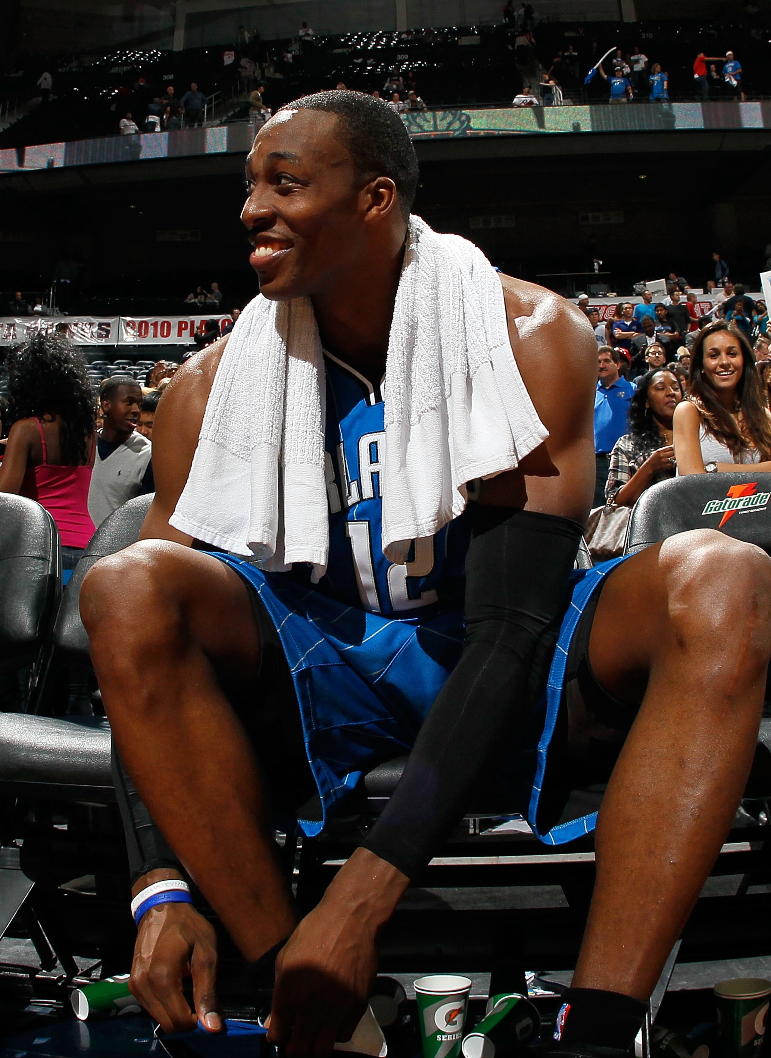 ATLANTA - MAY 10:  Dwight Howard #12 of the Orlando Magic smiles as he removes his shoes after their 98-84 win over the Atlanta Hawks in Game Four of the Eastern Conference Semifinals of the 2010 NBA Playoffs at Philips Arena on May 10, 2010 in Atlanta, G