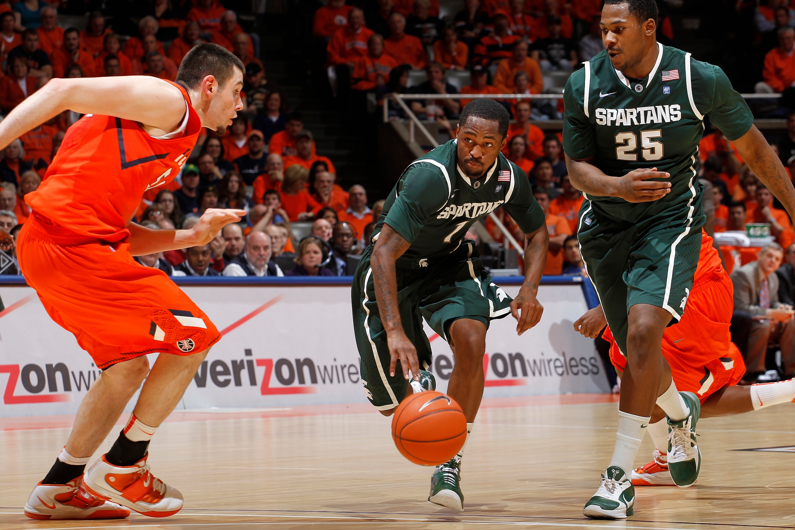 CHAMPAIGN, IL - JANUARY 18: Kalin Lucas #1 of the Michigan State Spartans tries to get past Mike Tisdale #54 of the Illinois Fighting Illini at Assembly Hall on January 18, 2011 in Champaign, Illinois. Illinois defeated Michigan State 71-62. (Photo by Joe