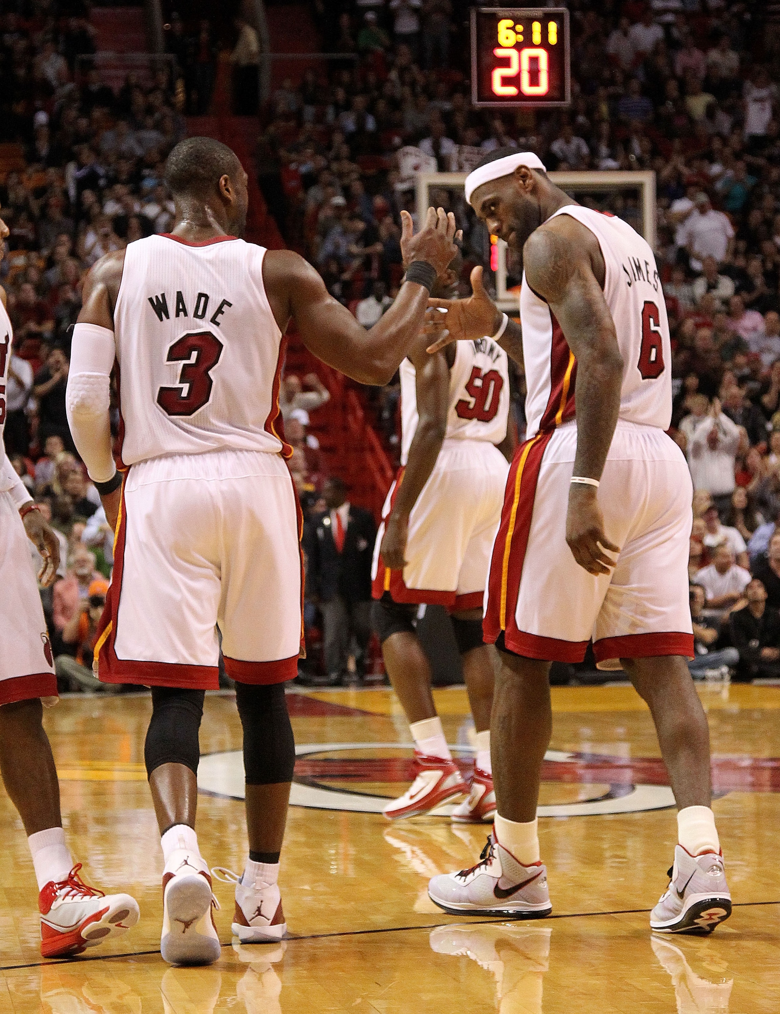 MIAMI, FL - JANUARY 31:  Dwyane Wade #3 and LeBron James #6 of the Miami Heat high five during a game against the Cleveland Cavaliers at American Airlines Arena on January 31, 2011 in Miami, Florida. NOTE TO USER: User expressly acknowledges and agrees th