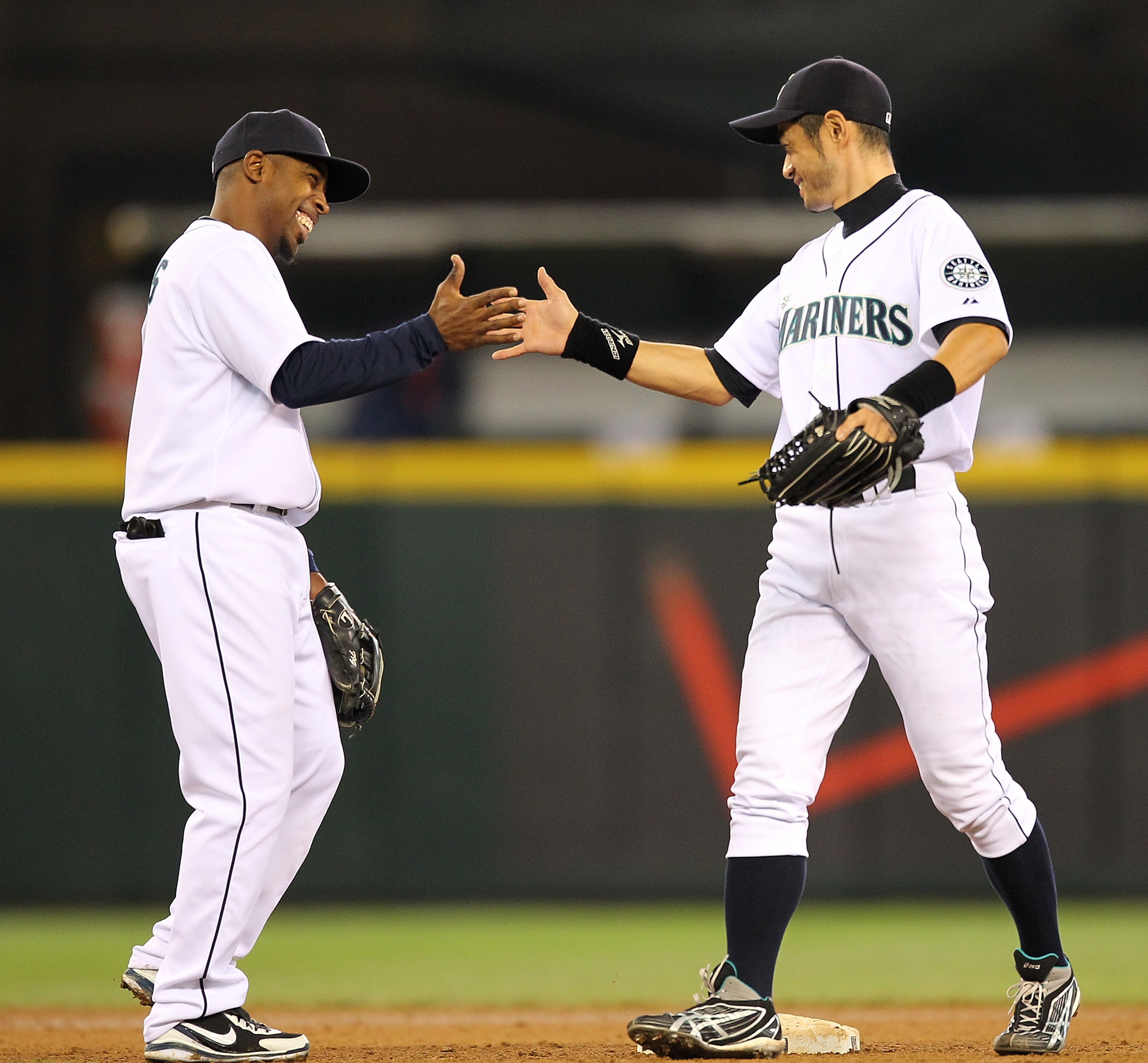 SEATTLE - MAY 26:  Ichiro Suzuki #51 (R) of the Seattle Mariners celebrates with Chone Figgins #9 after defeating the Detroit Tigers 5-4 at Safeco Field on May 26, 2010 in Seattle, Washington. (Photo by Otto Greule Jr/Getty Images)