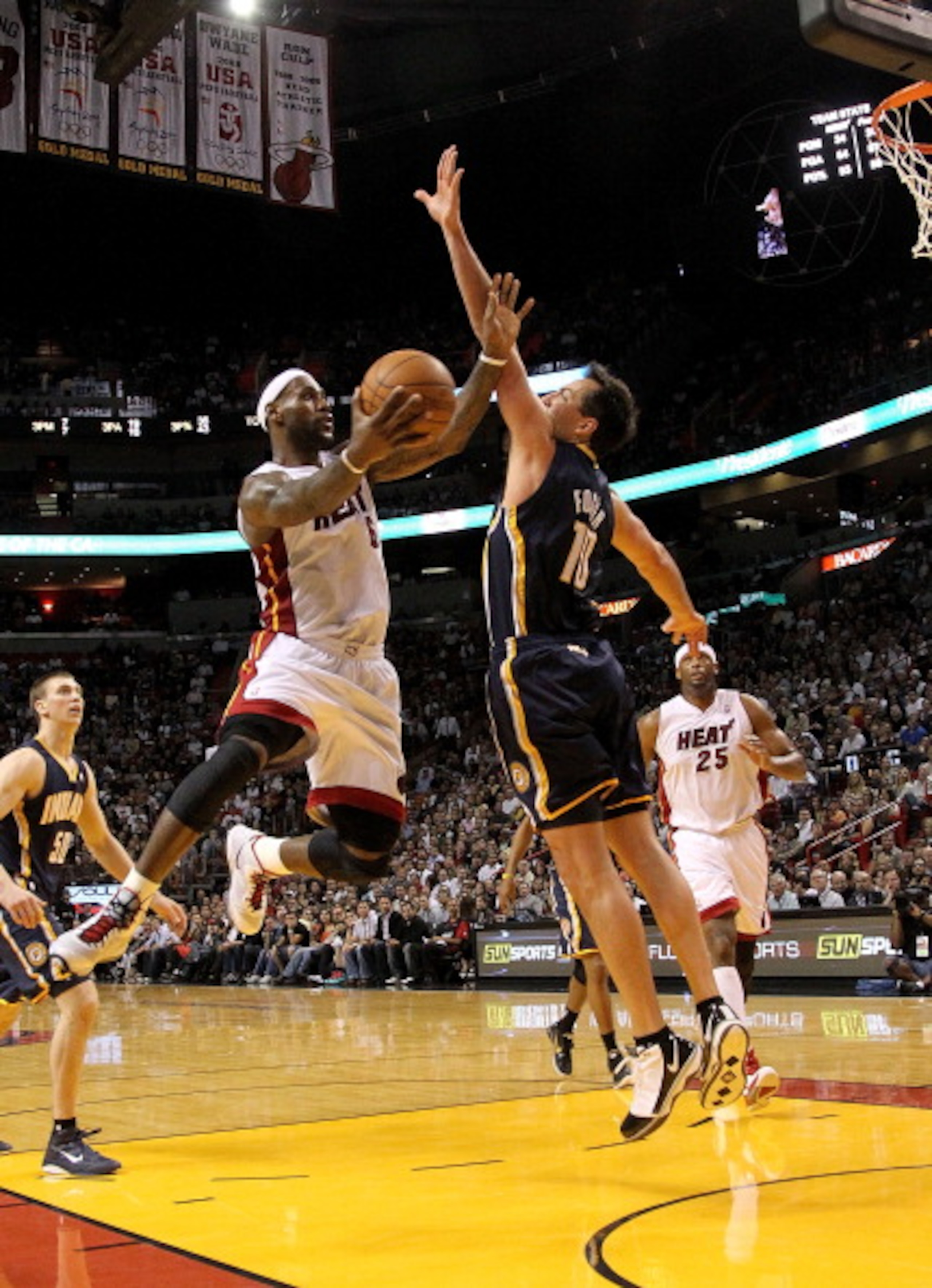 MIAMI, FL - FEBRUARY 08:  LeBron James #6 of the Miami Heat shoots over Jeff Foster #10 of the Indiana Pacers during a game at American Airlines Arena on February 8, 2011 in Miami, Florida. NOTE TO USER: User expressly acknowledges and agrees that, by dow
