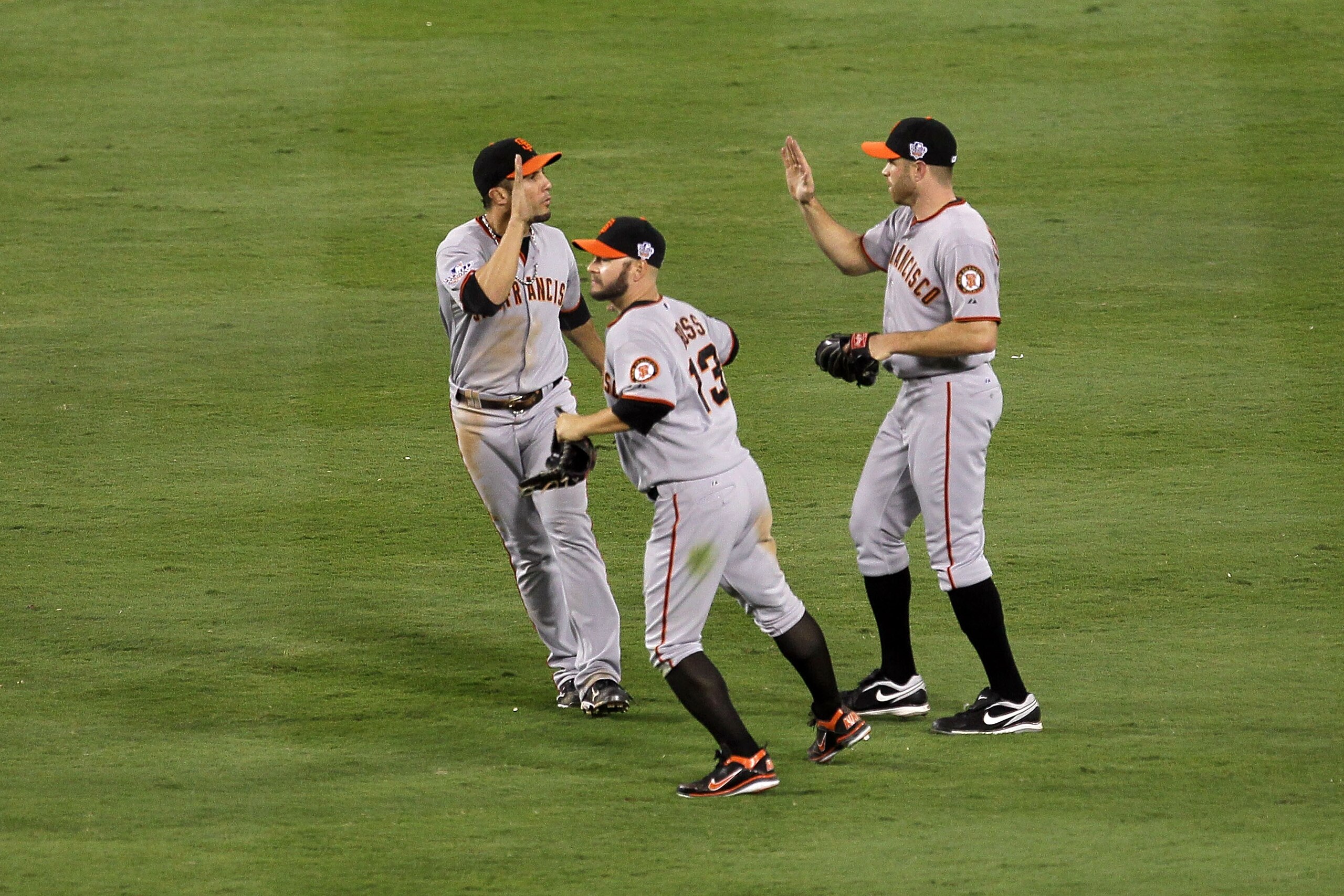 ARLINGTON, TX - OCTOBER 31: (L-R) Andres Torres #56, Cody Ross #13 and Nate Schierholtz #12 of the San Francisco Giants celebrate in the outfield after their 4-0 win against the Texas Rangers in Game Four of the 2010 MLB World Series at Rangers Ballpark ARLINGTON, TX - OCTOBER 31: (L-R) Andres Torres #56, Cody Ross #13 and Nate Schierholtz #12 of the San Francisco Giants celebrate in the outfield after their 4-0 win against the Texas Rangers in Game Four of the 2010 MLB World Series at Rangers Ballpark