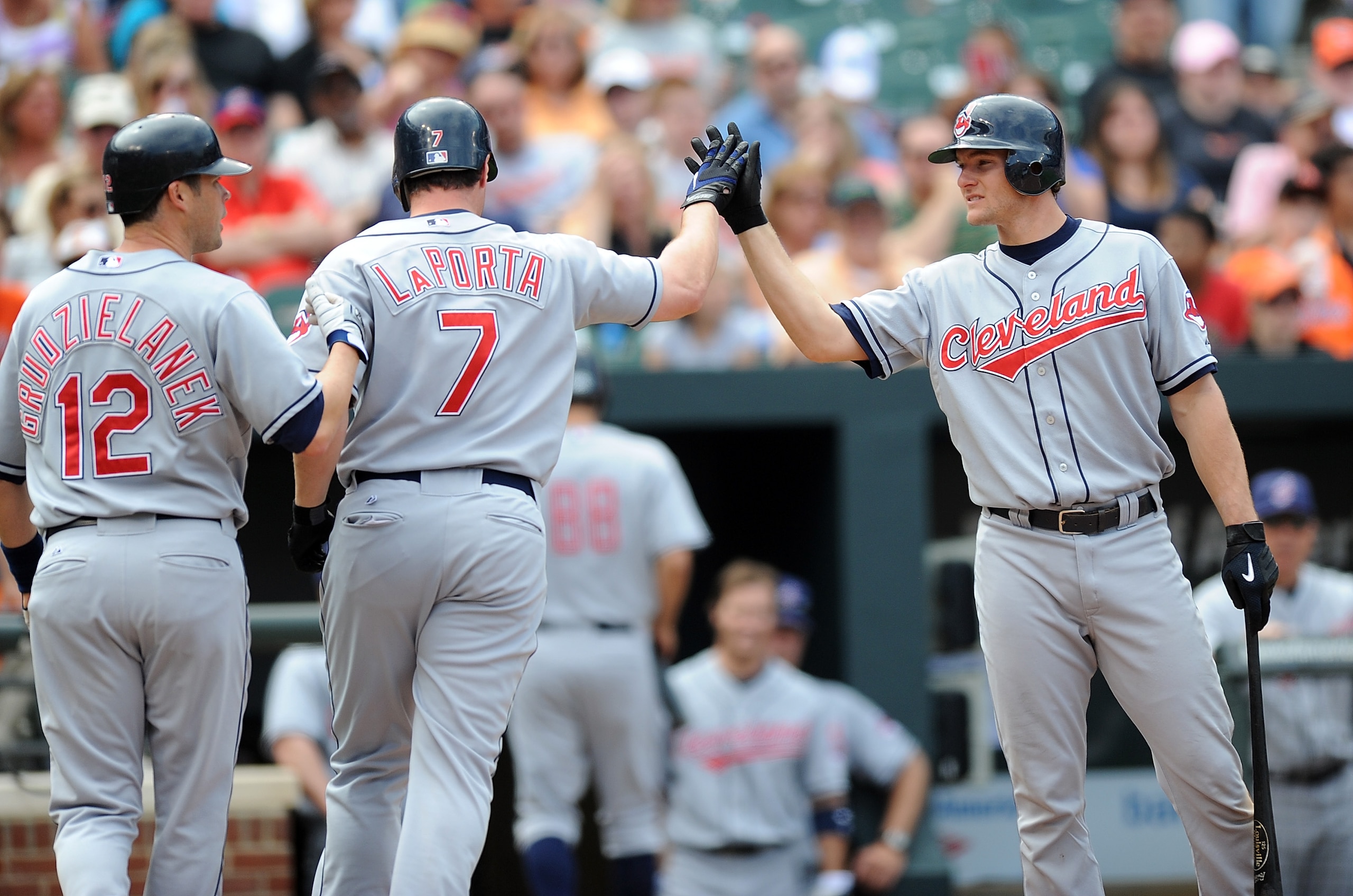 BALTIMORE - MAY 16: Matt LaPorta #7 of the Cleveland Indians is congratulated by Mark Grudzielanek #12 and Lou Marson #30 after hitting a home run in the fifth inning against the Baltimore Orioles at Camden Yards on May 16, 2010 in Baltimore, Maryland. BALTIMORE - MAY 16: Matt LaPorta #7 of the Cleveland Indians is congratulated by Mark Grudzielanek #12 and Lou Marson #30 after hitting a home run in the fifth inning against the Baltimore Orioles at Camden Yards on May 16, 2010 in Baltimore, Maryland.