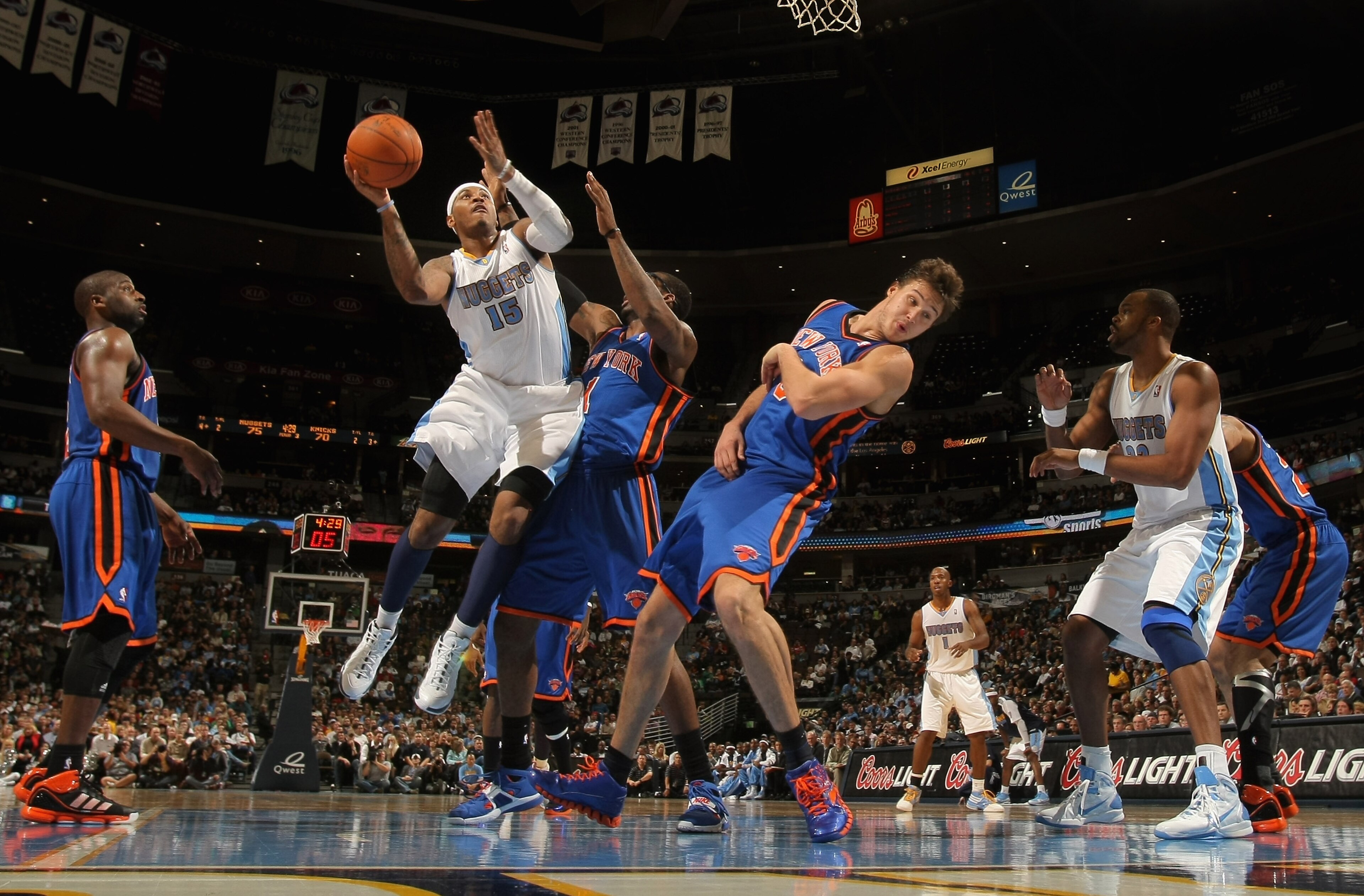 DENVER - NOVEMBER 16: Carmelo Anthony #15 of the Denver Nuggets puts up a shot over Amar'e Stoudemire #1 and Danilo Gallinari #8 of the New York Knicks at the Pepsi Center on November 16, 2010 in Denver, Colorado. The Nuggets defeated the Knicks 120-118. DENVER - NOVEMBER 16: Carmelo Anthony #15 of the Denver Nuggets puts up a shot over Amar'e Stoudemire #1 and Danilo Gallinari #8 of the New York Knicks at the Pepsi Center on November 16, 2010 in Denver, Colorado. The Nuggets defeated the Knicks 120-118.