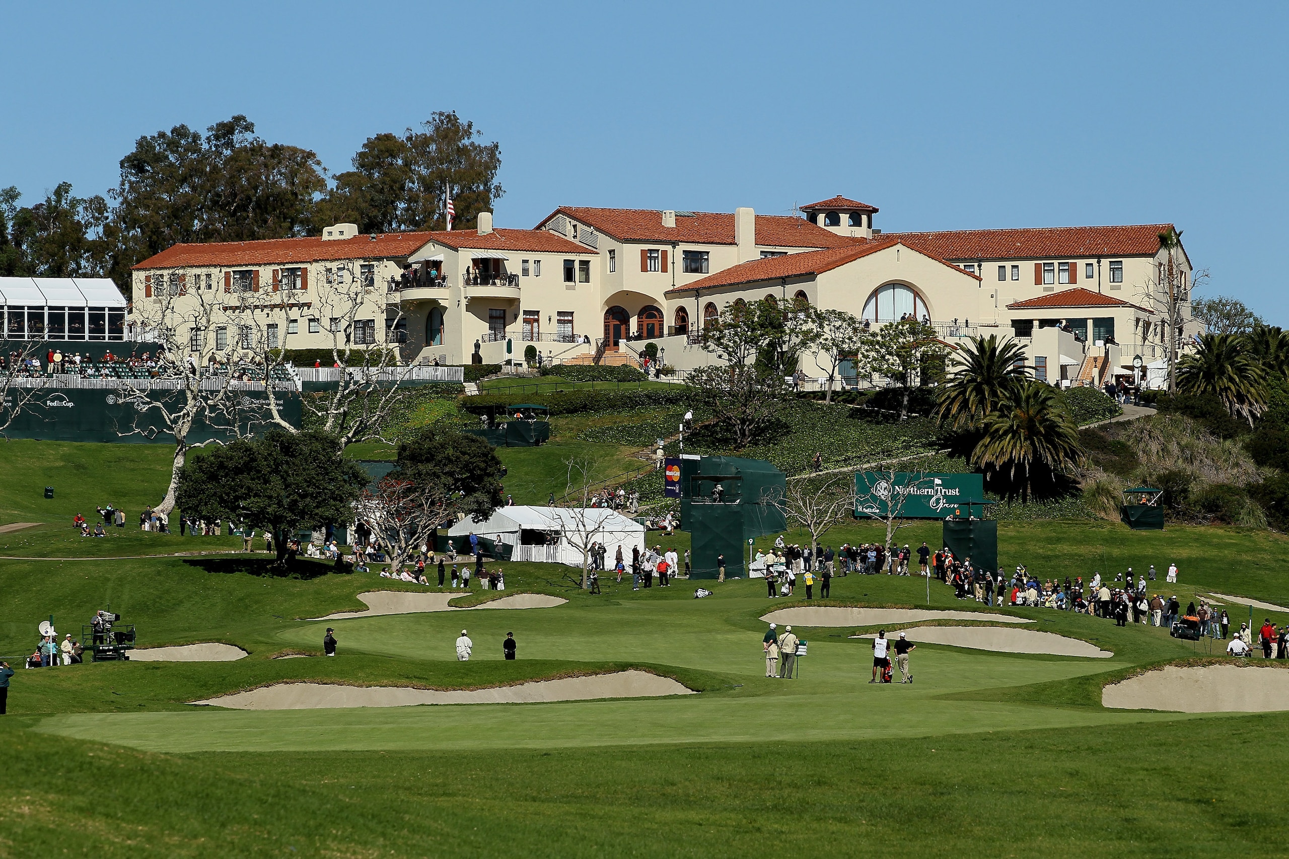 PACIFIC PALISADES, CA - FEBRUARY 07: A group plays the ninth hole beneath the clubhouse during the final round of the Northern Trust Open at Riviera Country Club on February 7, 2010 in Pacific Palisades, California. (Photo by Stephen Dunn/Getty Images) PACIFIC PALISADES, CA - FEBRUARY 07: A group plays the ninth hole beneath the clubhouse during the final round of the Northern Trust Open at Riviera Country Club on February 7, 2010 in Pacific Palisades, California. (Photo by Stephen Dunn/Getty Images)
