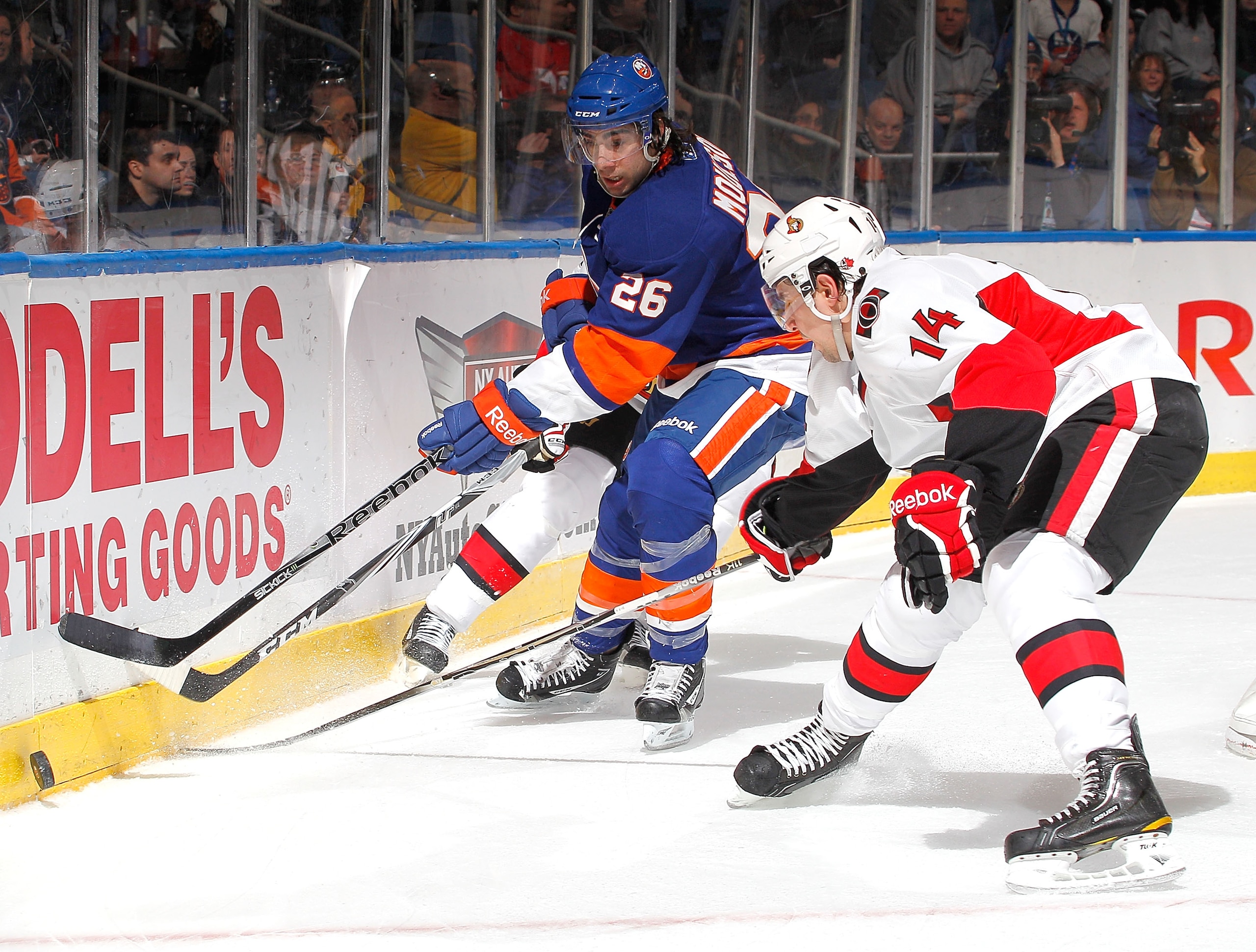 UNIONDALE, NY - FEBRUARY 05:  Matt Moulson #26 of the New York Islanders passes the puck during an NHL hockey game against the Ottawa Senators at Nassau Coliseum on February 5, 2011 in Uniondale, New York.  (Photo by Paul Bereswill/Getty Images)