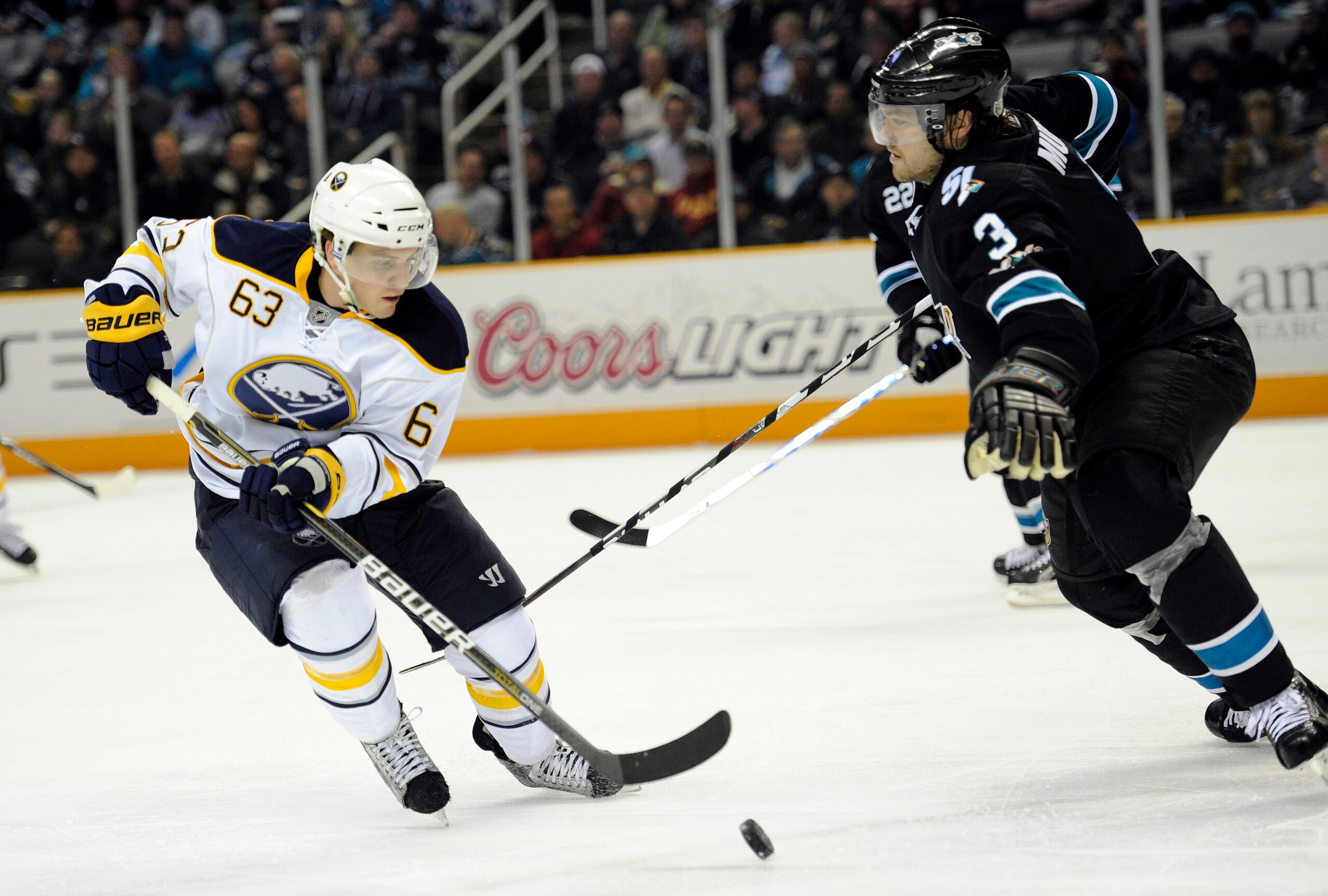 SAN JOSE, CA - JANUARY 6:  Tyler Ennis #63 of the Buffalo Sabres looks to get control of the puck in front of Douglas Murray #3 of the San Jose Sharks in the third period of an NHL hockey game at the HP Pavilion on January 6, 2011 in San Jose, California.