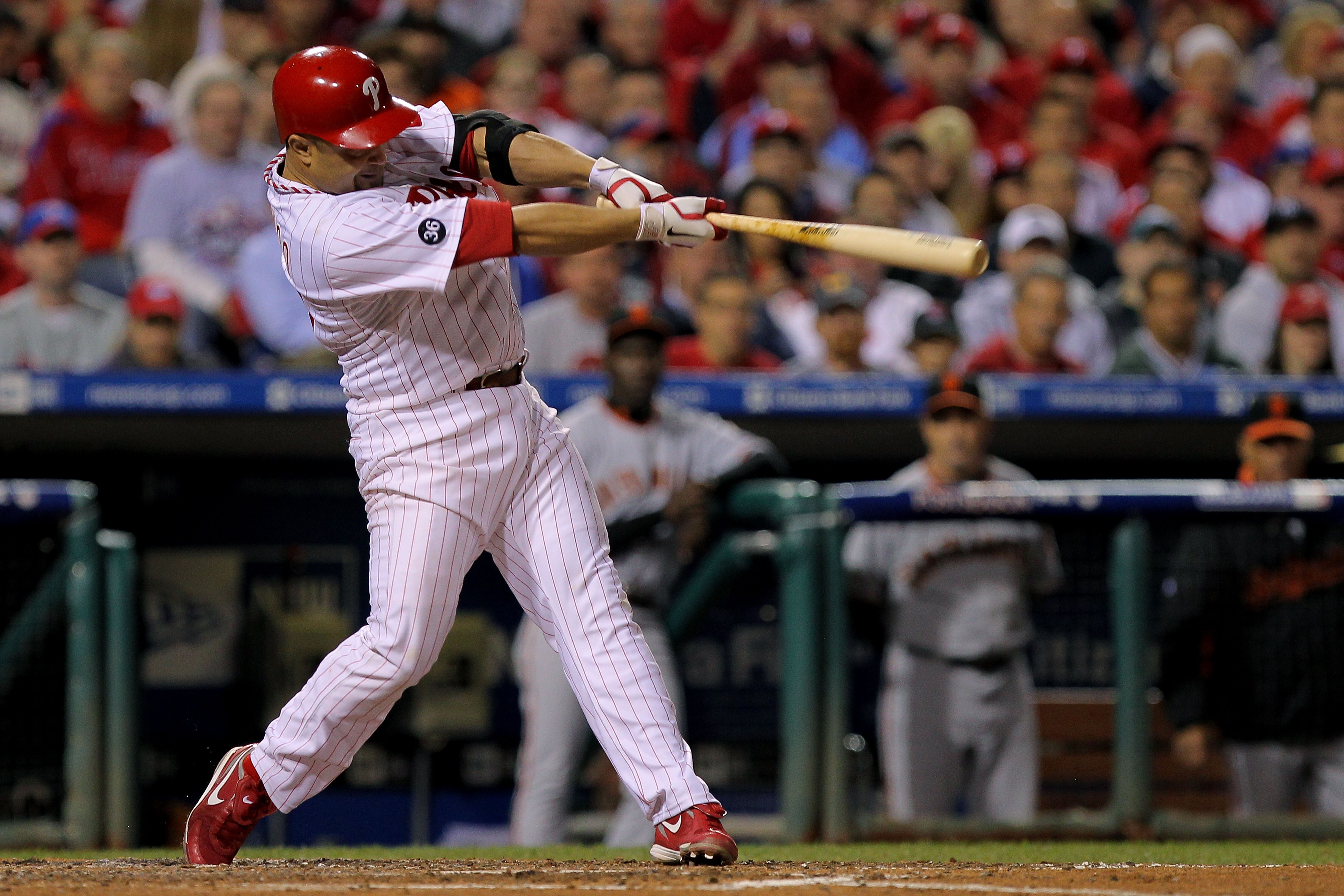 PHILADELPHIA - OCTOBER 17:  Placido Polanco #27 of the Philadelphia Phillies connects for a sacrifice fly to score Shane Victorino against the San Francisco Giants in Game Two of the NLCS during the 2010 MLB Playoffs at Citizens Bank Park on October 17, 2