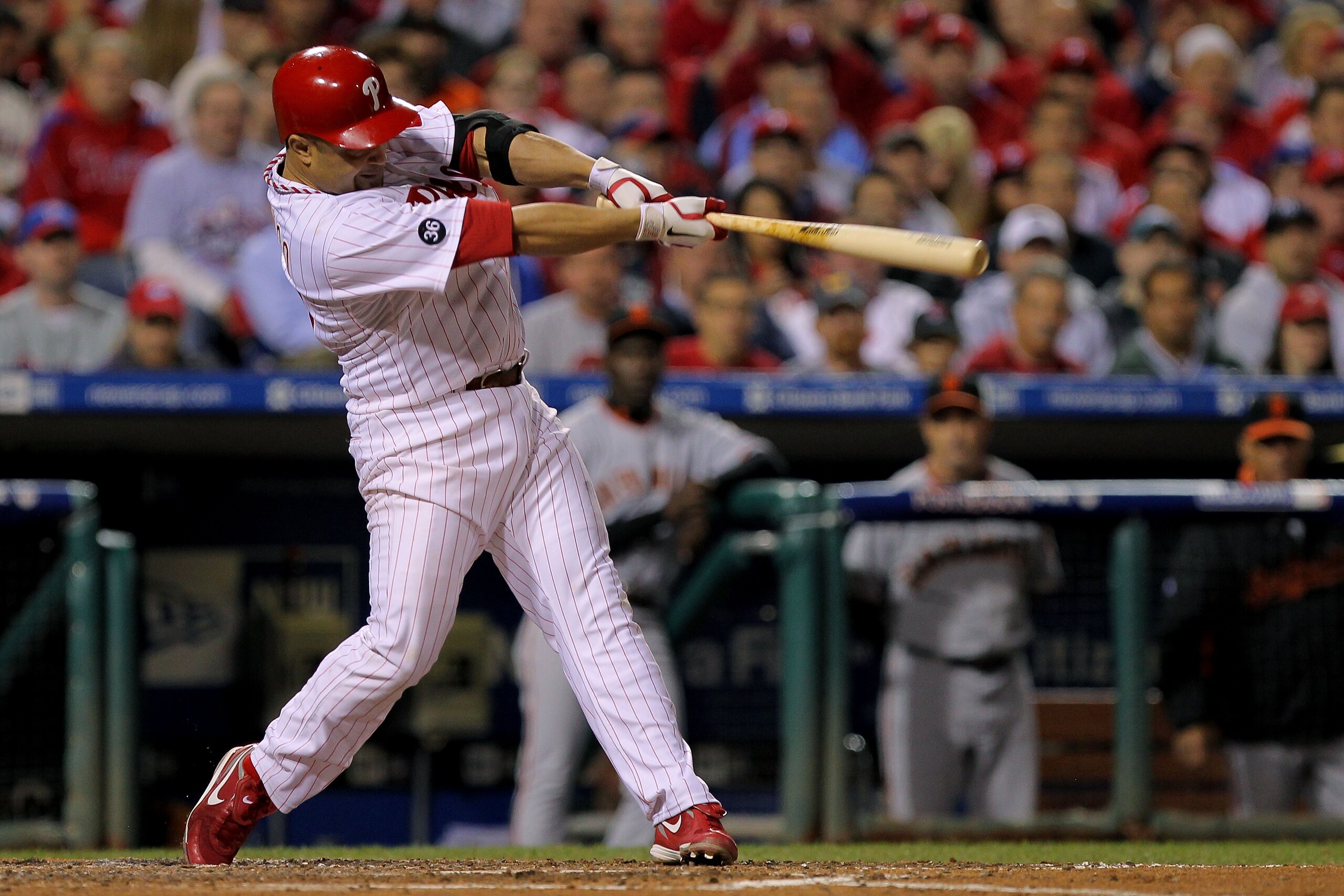 PHILADELPHIA - OCTOBER 17: Placido Polanco #27 of the Philadelphia Phillies connects for a sacrifice fly to score Shane Victorino against the San Francisco Giants in Game Two of the NLCS during the 2010 MLB Playoffs at Citizens Bank Park on October 17, 2 PHILADELPHIA - OCTOBER 17: Placido Polanco #27 of the Philadelphia Phillies connects for a sacrifice fly to score Shane Victorino against the San Francisco Giants in Game Two of the NLCS during the 2010 MLB Playoffs at Citizens Bank Park on October 17, 2