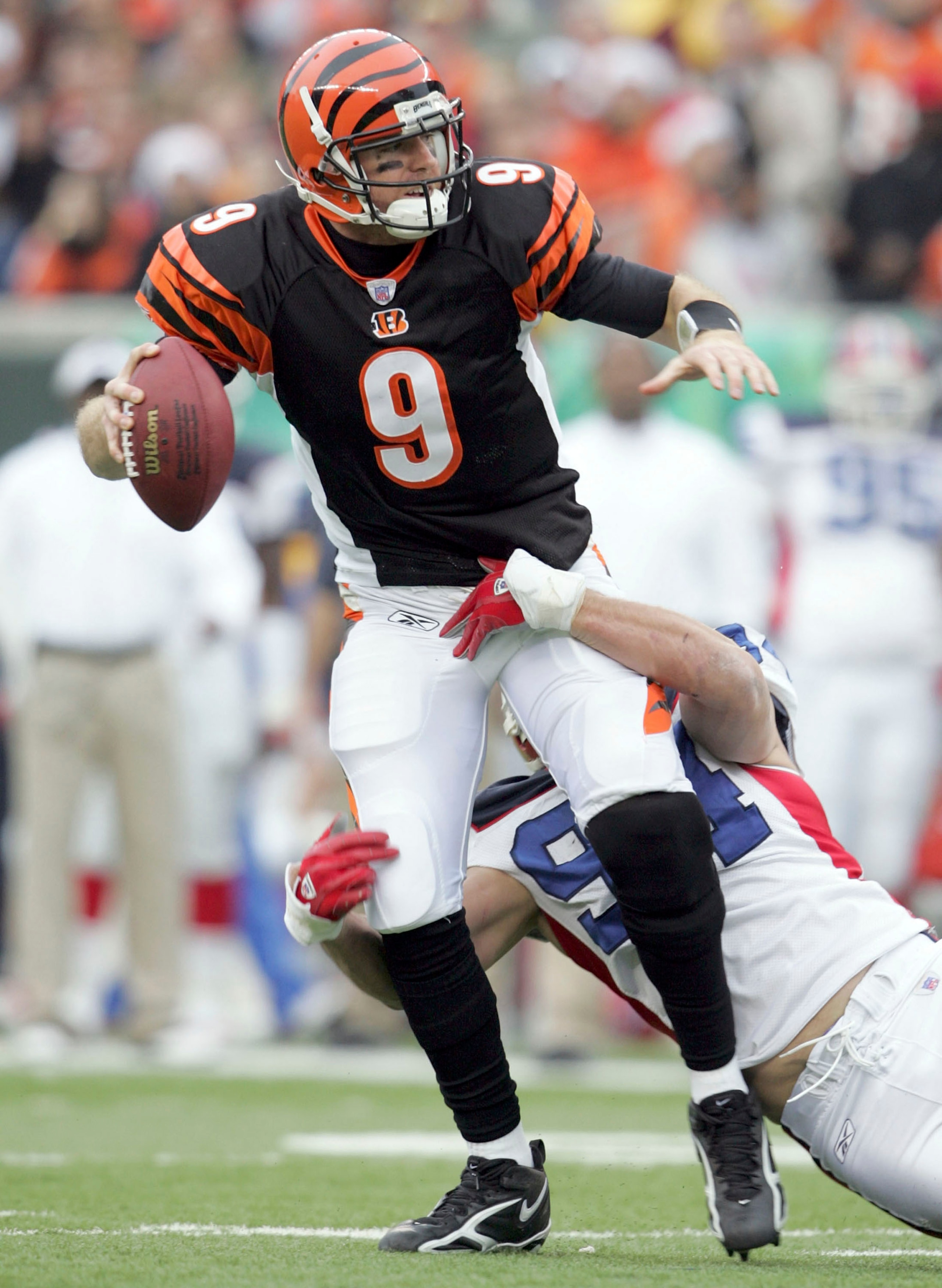 CINCINNATI - DECEMBER 24:  Carson Palmer #9 of the Cincinnati Bengals is sacked by Aaron Schobel #94 of the Buffalo Bills during the NFL game at Paul Brown Stadium on December 24, 2005 in Cincinnati, Ohio. The Bills won 37-27.  (Photo by Andy Lyons/Getty