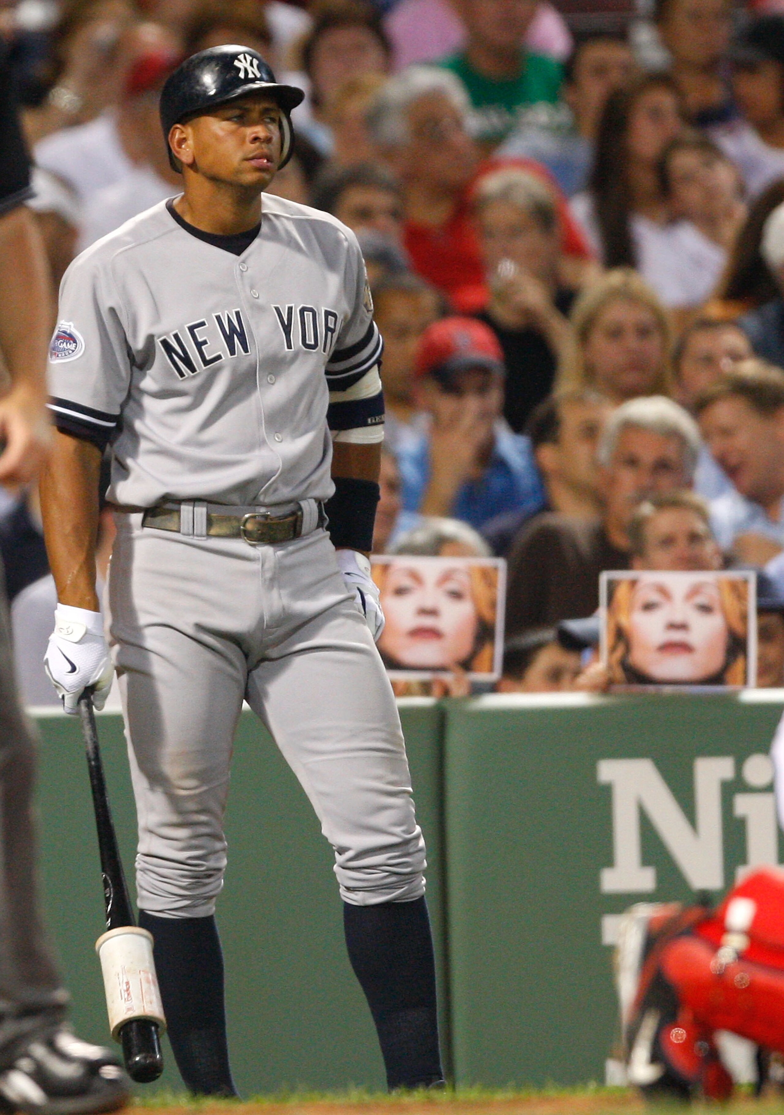 BOSTON - JULY 25: Fans hold pictures of Madonna as Alex Rodriguez #13 of the New York Yankees prepares to bat against the Boston Red Sox at Fenway Park on July 25, 2008 in Boston, Massachusetts.  (Photo by Jim Rogash/Getty Images)