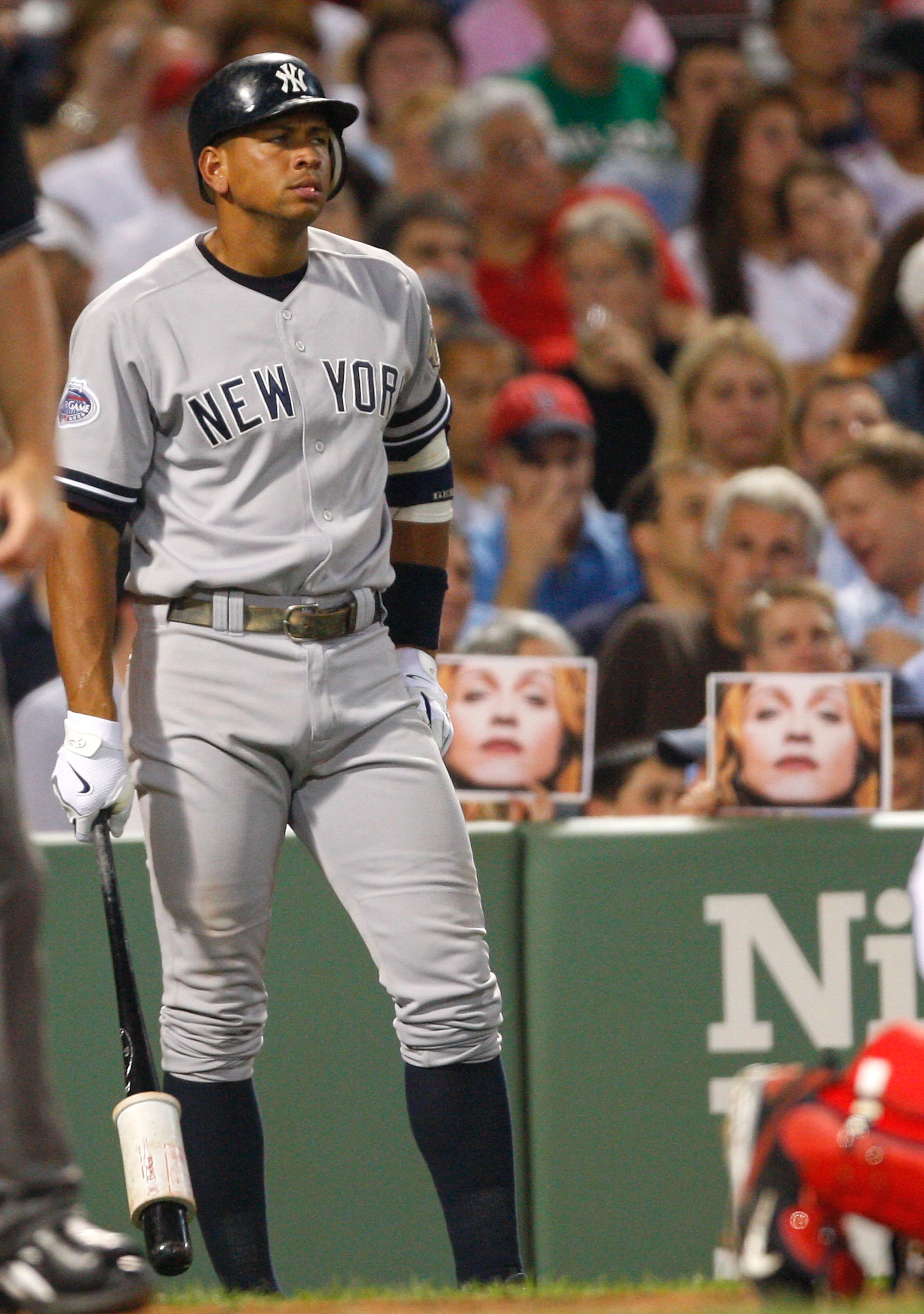 BOSTON - JULY 25: Fans hold pictures of Madonna as Alex Rodriguez #13 of the New York Yankees prepares to bat against the Boston Red Sox at Fenway Park on July 25, 2008 in Boston, Massachusetts.  (Photo by Jim Rogash/Getty Images)