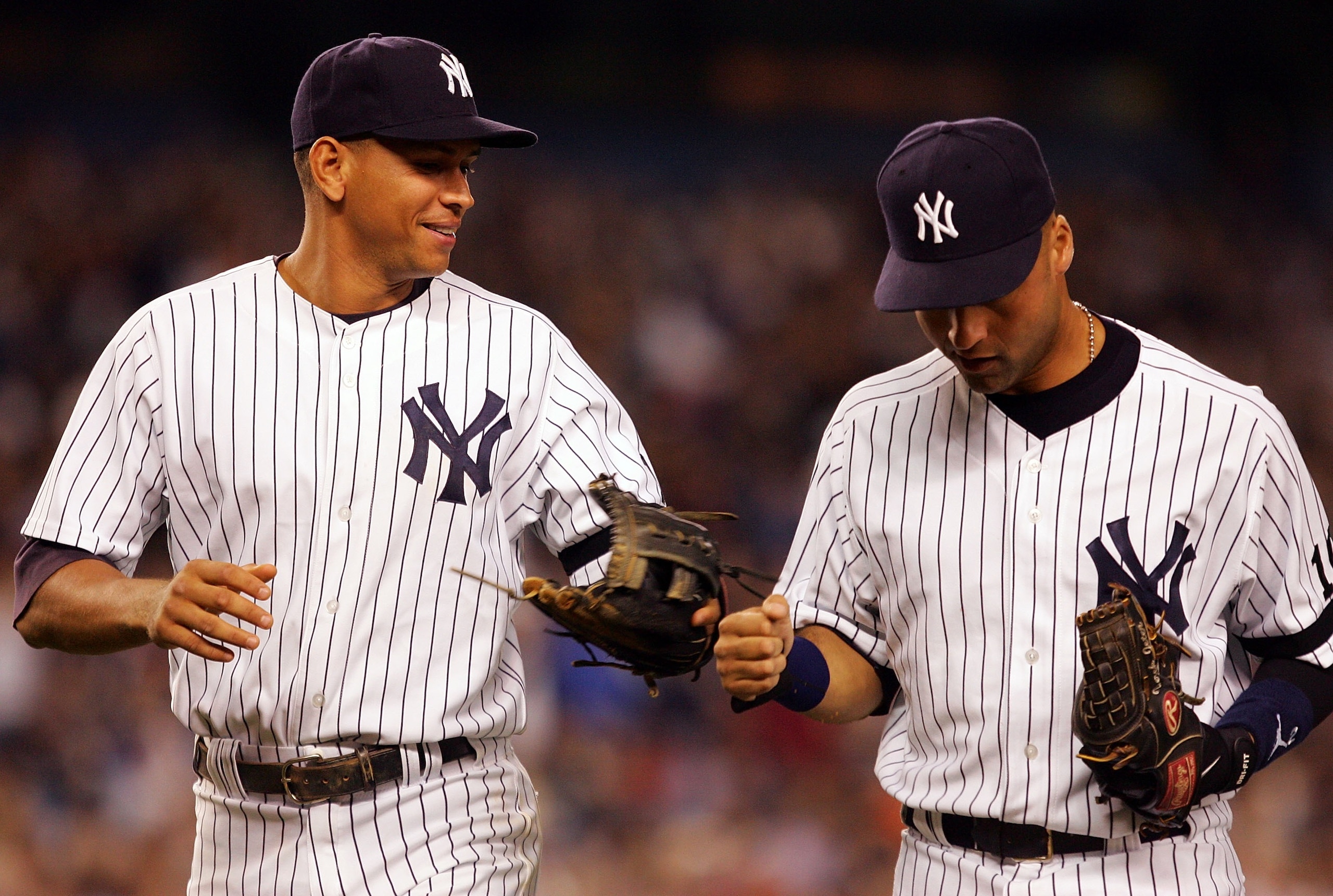 NEW YORK - SEPTEMBER 19: Alex Rodriguez #13 (L) and Derek Jeter #2 of the New York Yankees celebrate an inning double play against the Baltimore Orioles during their game at Yankee Stadium on September 19, 2007 in the Bronx borough of New York City.  (Pho