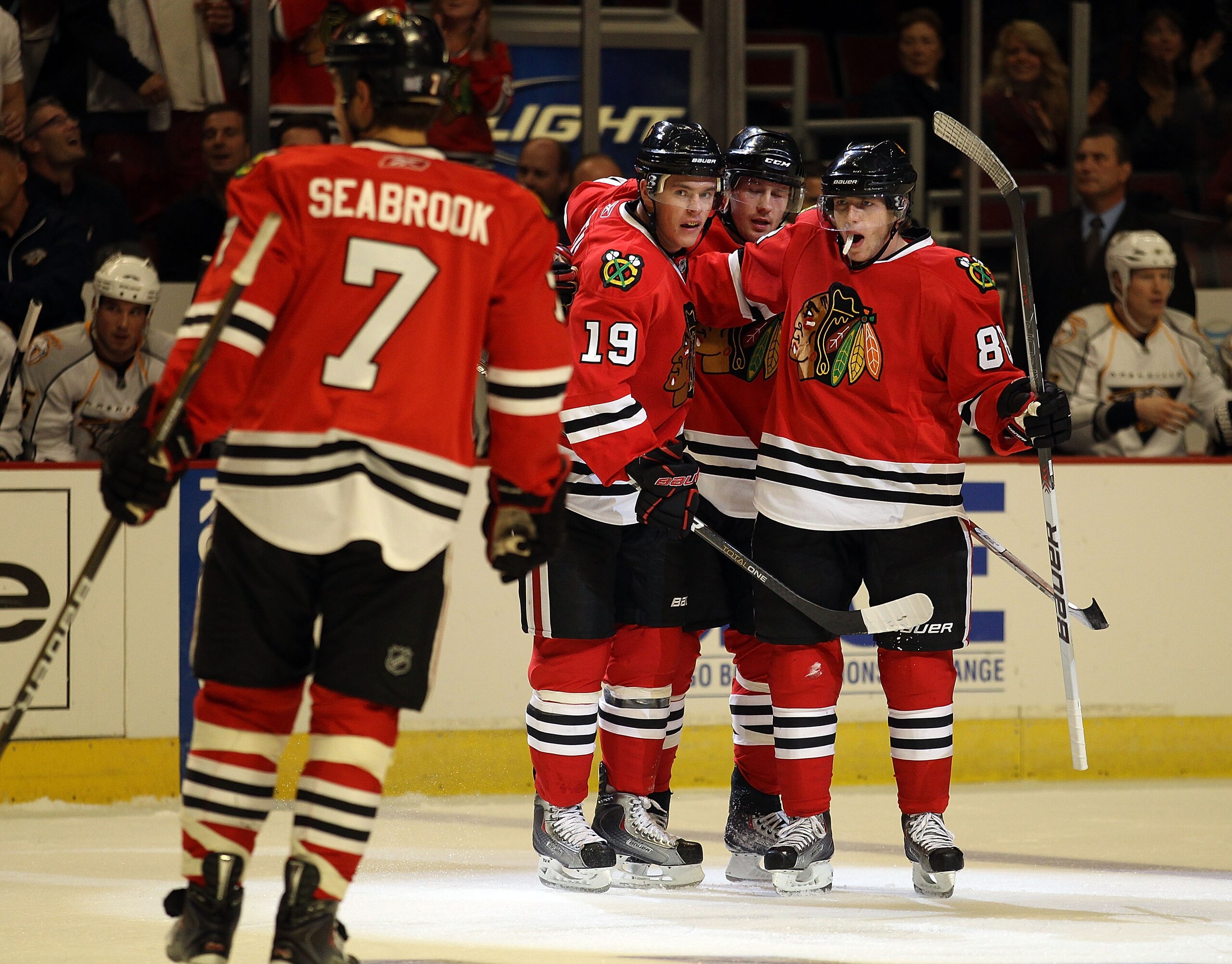 CHICAGO - OCTOBER 13: Patrick Kane #88 of the Chicago Blackhawks (R) celebrates a 1st period goal with teammates (L-R) Brent Seabrook #7, Jonathan Toews #19 and Duncan Keith #2 against the Nashville Predators at the United Center on October 13, 2010 in Ch