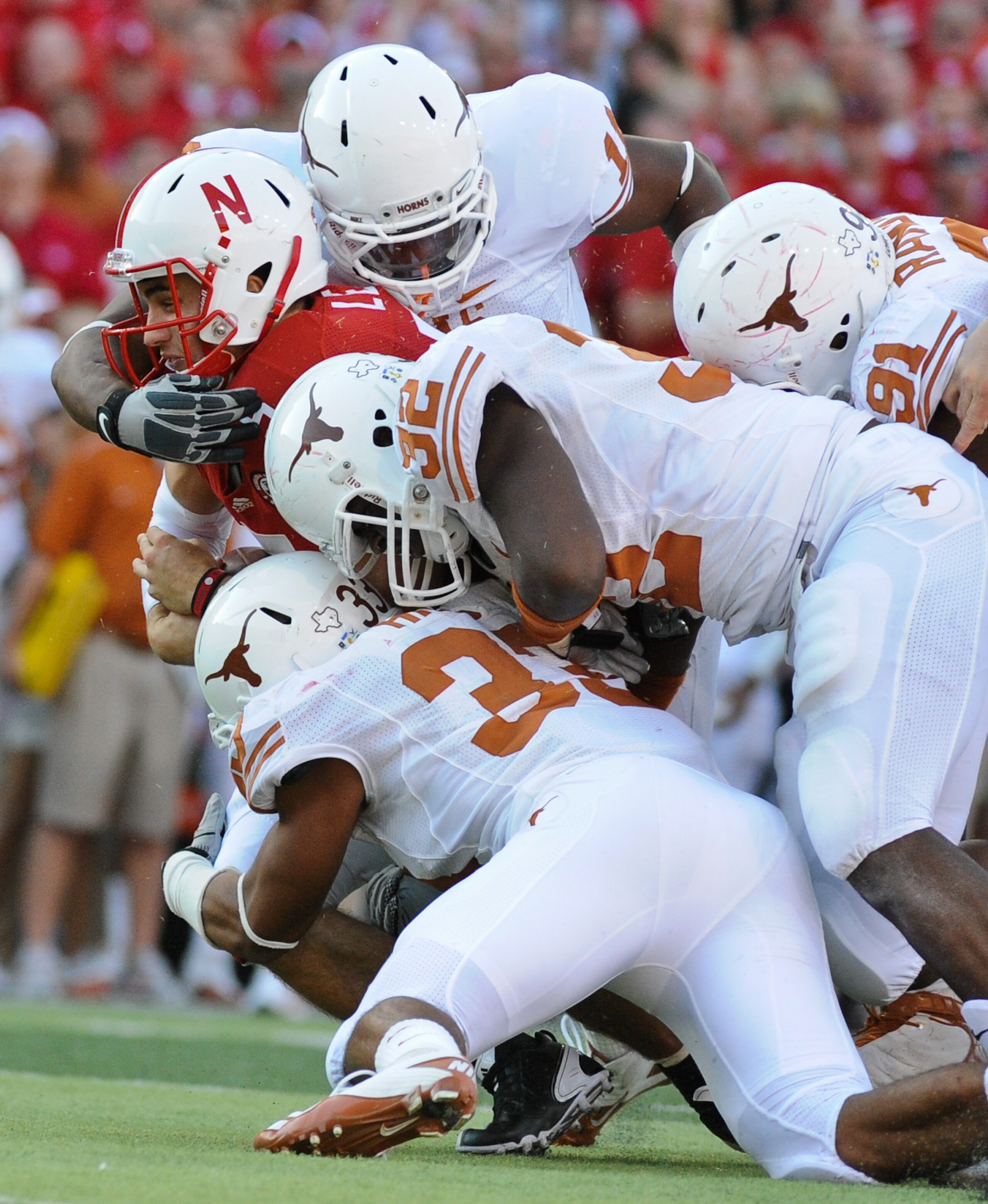 LINCOLN, NE - OCTOBER 16: Quarterback Zac Lee #5 of the Nebraska Cornhuskers is tackled by the Texas longhorn defense during second half action of their game at Memorial Stadium on October 16, 2010 in Lincoln, Nebraska. Texas Defeated Nebraska 20-13. (Pho