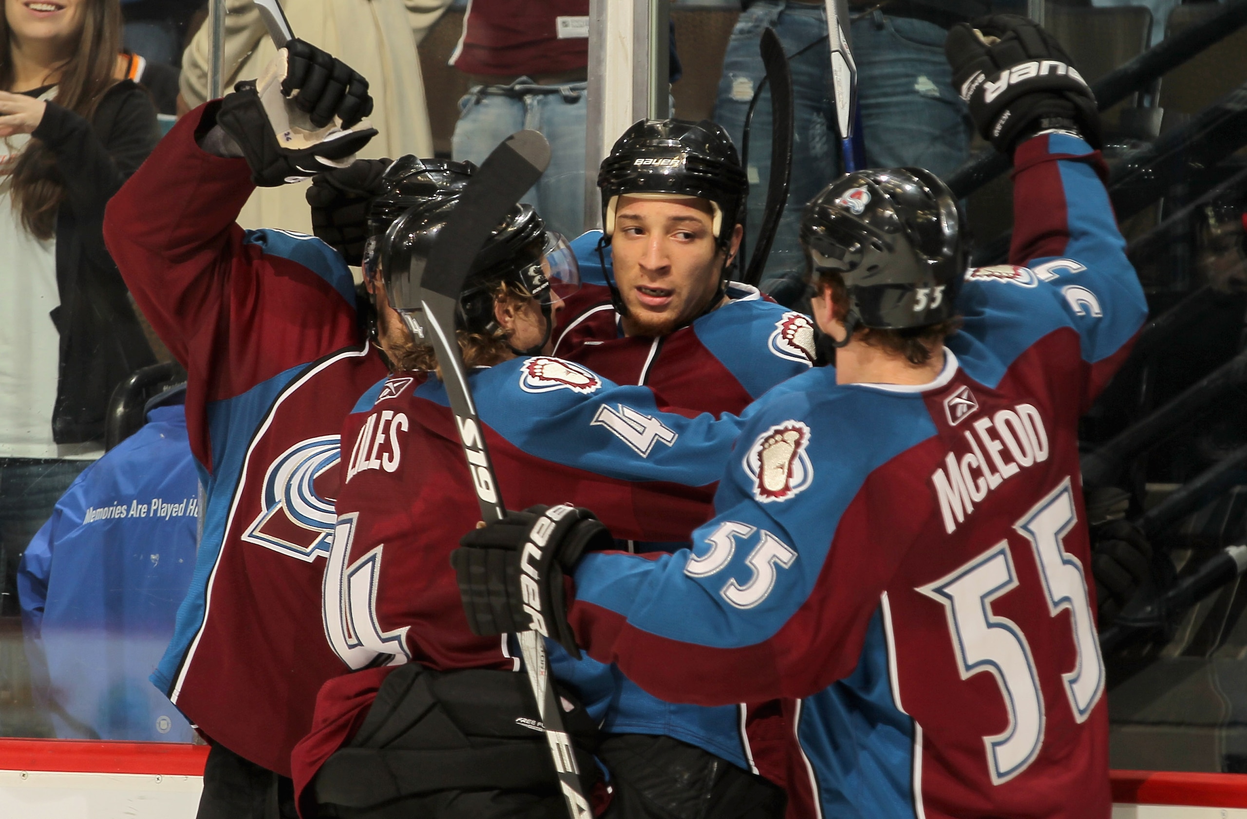 DENVER - NOVEMBER 17:  Chris Stewart #25 (C) of the Colorado Avalanche celebrates his third period goal against the San Jose Sharks John-Michael Liles #4 and Cody McLeod #55 at the Pepsi Center on November 17, 2010 in Denver, Colorado. The Avalanche defea