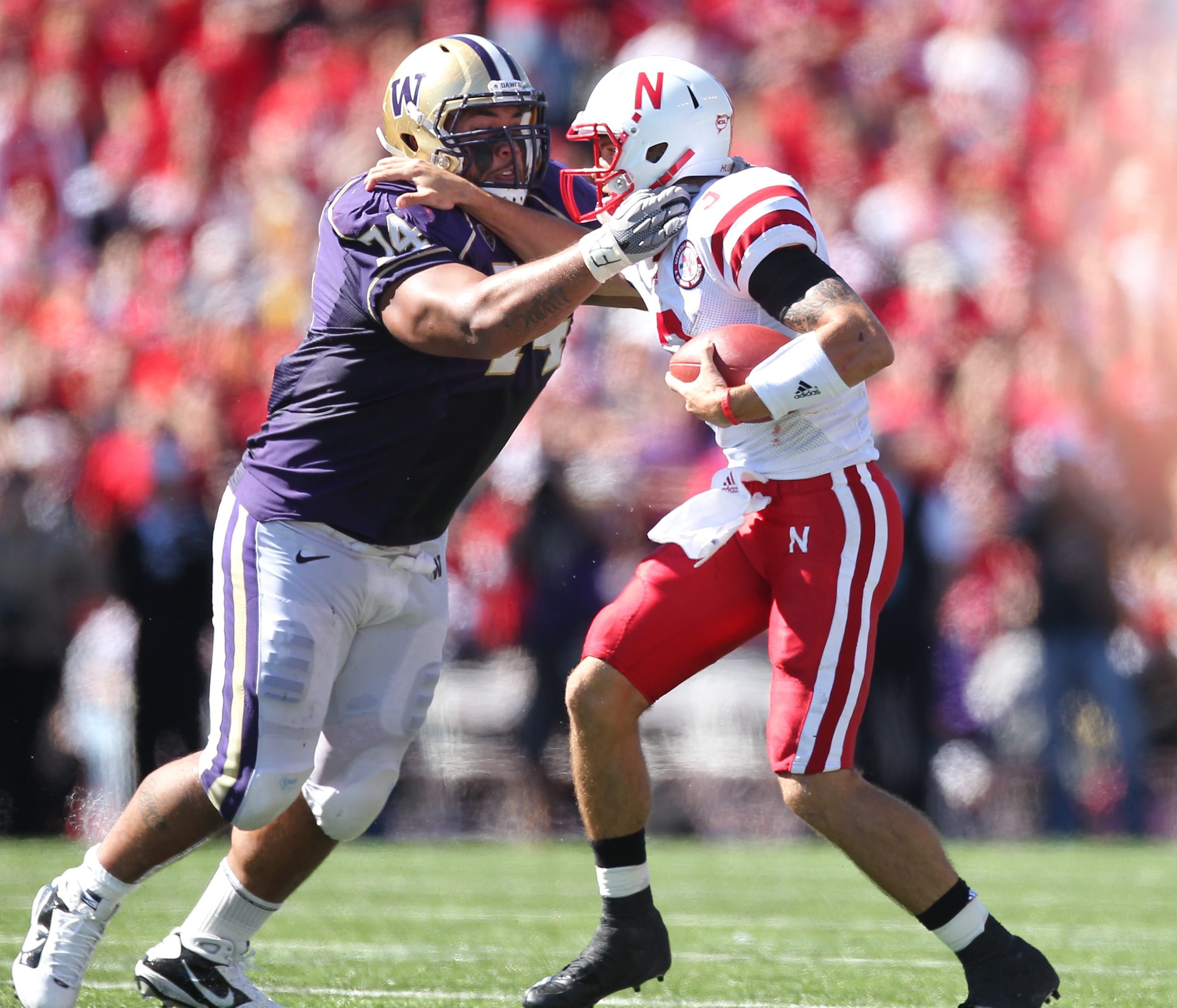 SEATTLE - SEPTEMBER 18: Quarterback Taylor Martinez #3 of the Nebraska Cornhuskers is tackled by Alameda Ta'amu #74 of the Washington Huskies on September 18, 2010 at Husky Stadium in Seattle, Washington. (Photo by Otto Greule Jr/Getty Images)