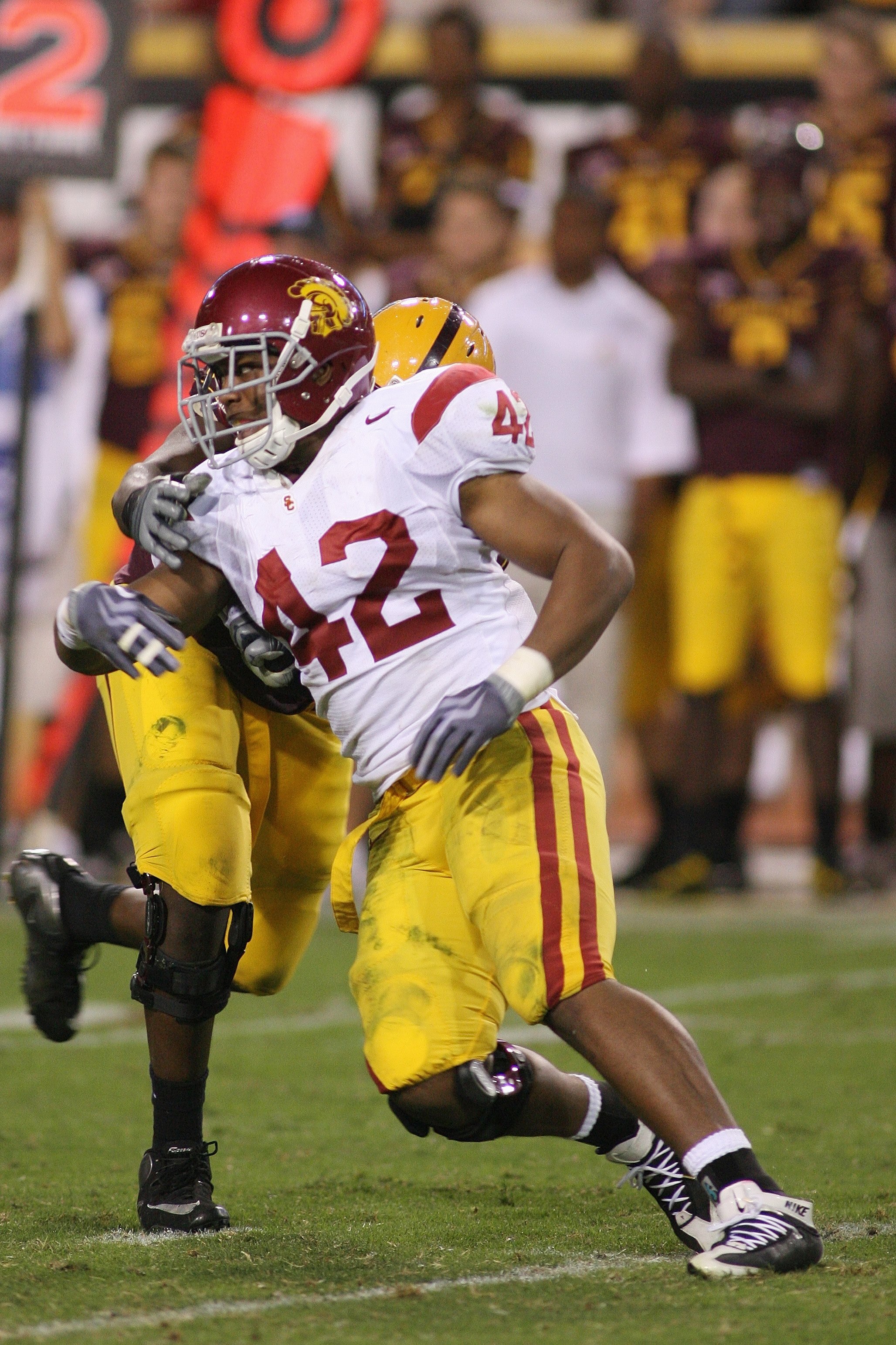 TEMPE, AZ - NOVEMBER 7:  Devon Kennard #42 of the USC Trojans rushes against the Arizona State Sun Devils on November 7, 2009 at Sun Devil Stadium in Tempe, Arizona.  USC won 14-9.  (Photo by Jeff Golden/Getty Images)