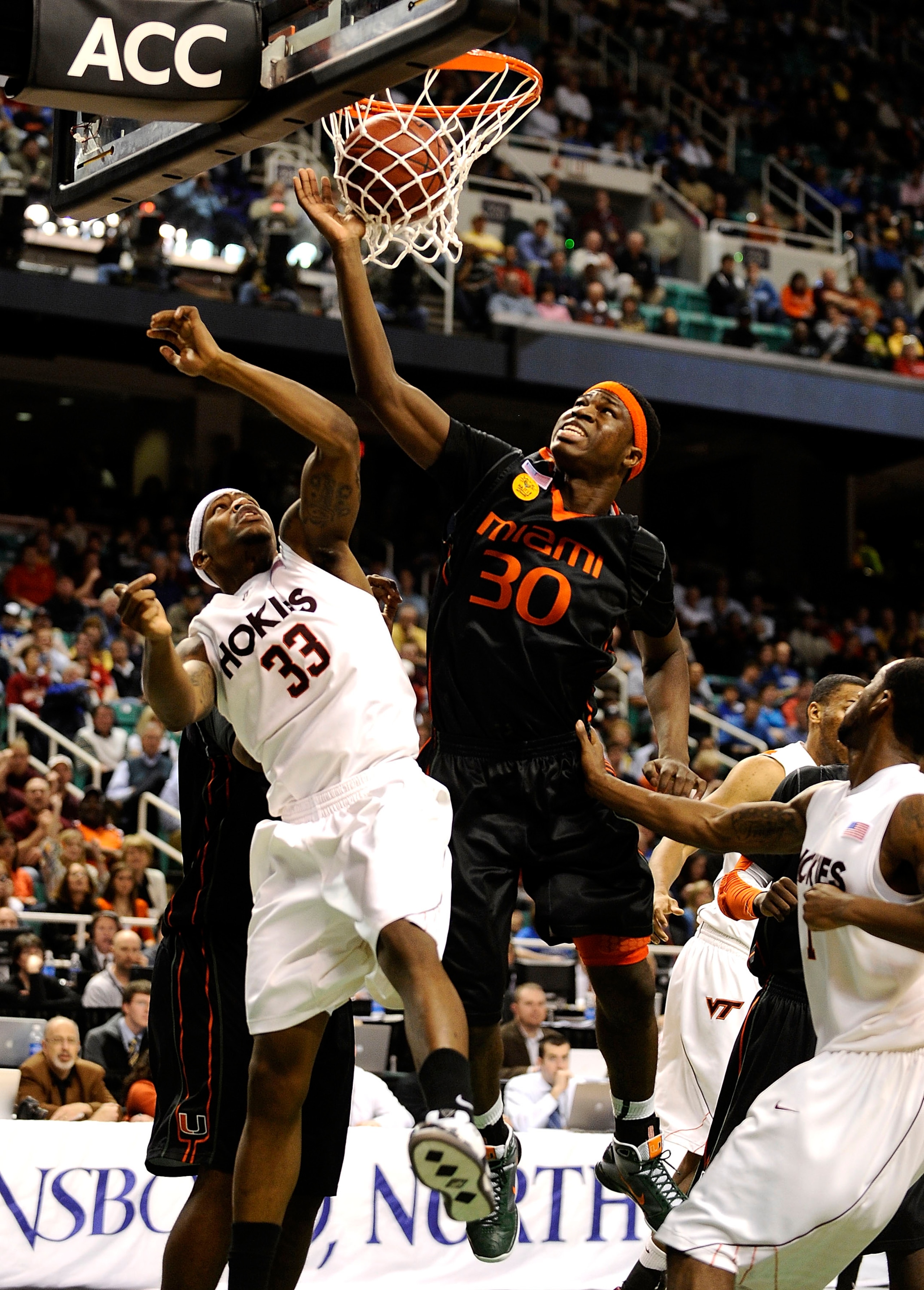 GREENSBORO, NC - MARCH 12:  JT Thompson #33 of the Virginia Tech Hokies defends against Adrian Thomas #30 of the University of Miami Hurricanes in their quarterfinal game in the 2010 ACC Men's Basketball Tournament at the Greensboro Coliseum on March 12,