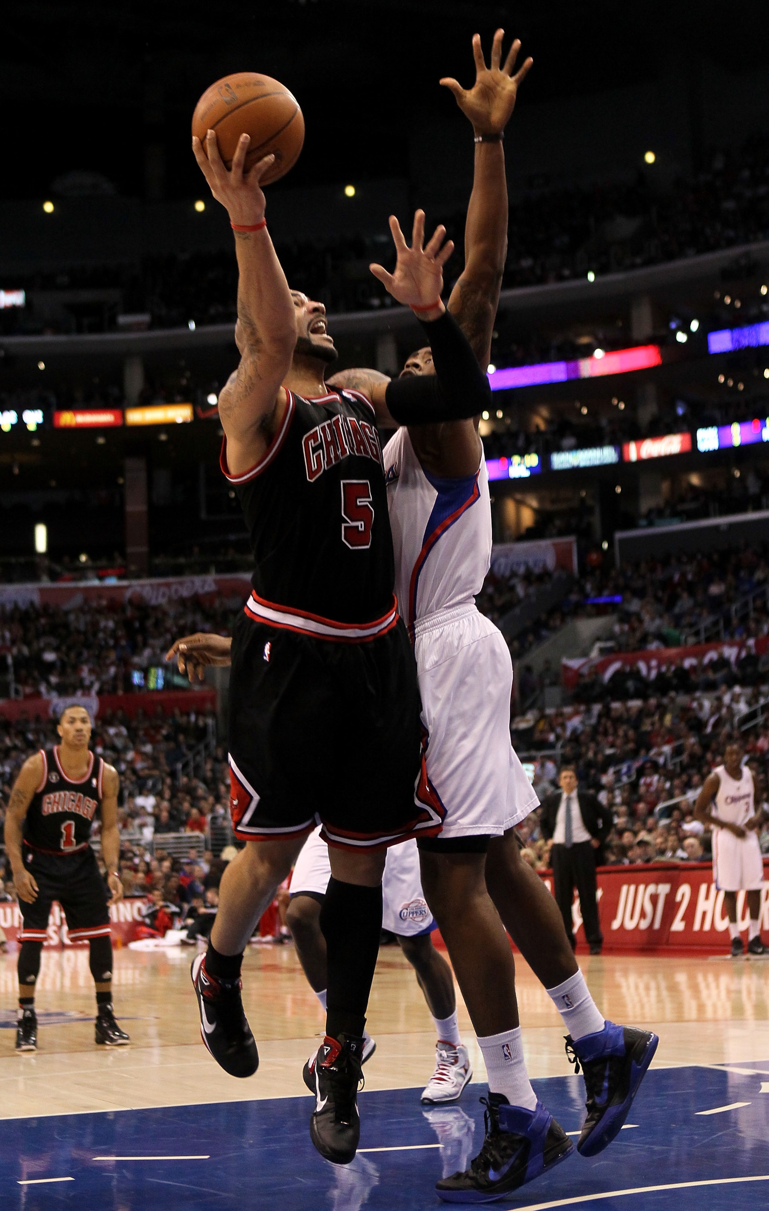 LOS ANGELES, CA - FEBRUARY 02:  Carlos Boozer #5 of the Chicago Bulls shoots over DeAndre Jordan #19 of the Los Angeles Clippers at Staples Center on February 2, 2011  in Los Angeles, California.  NOTE TO USER: User expressly acknowledges and agrees that,