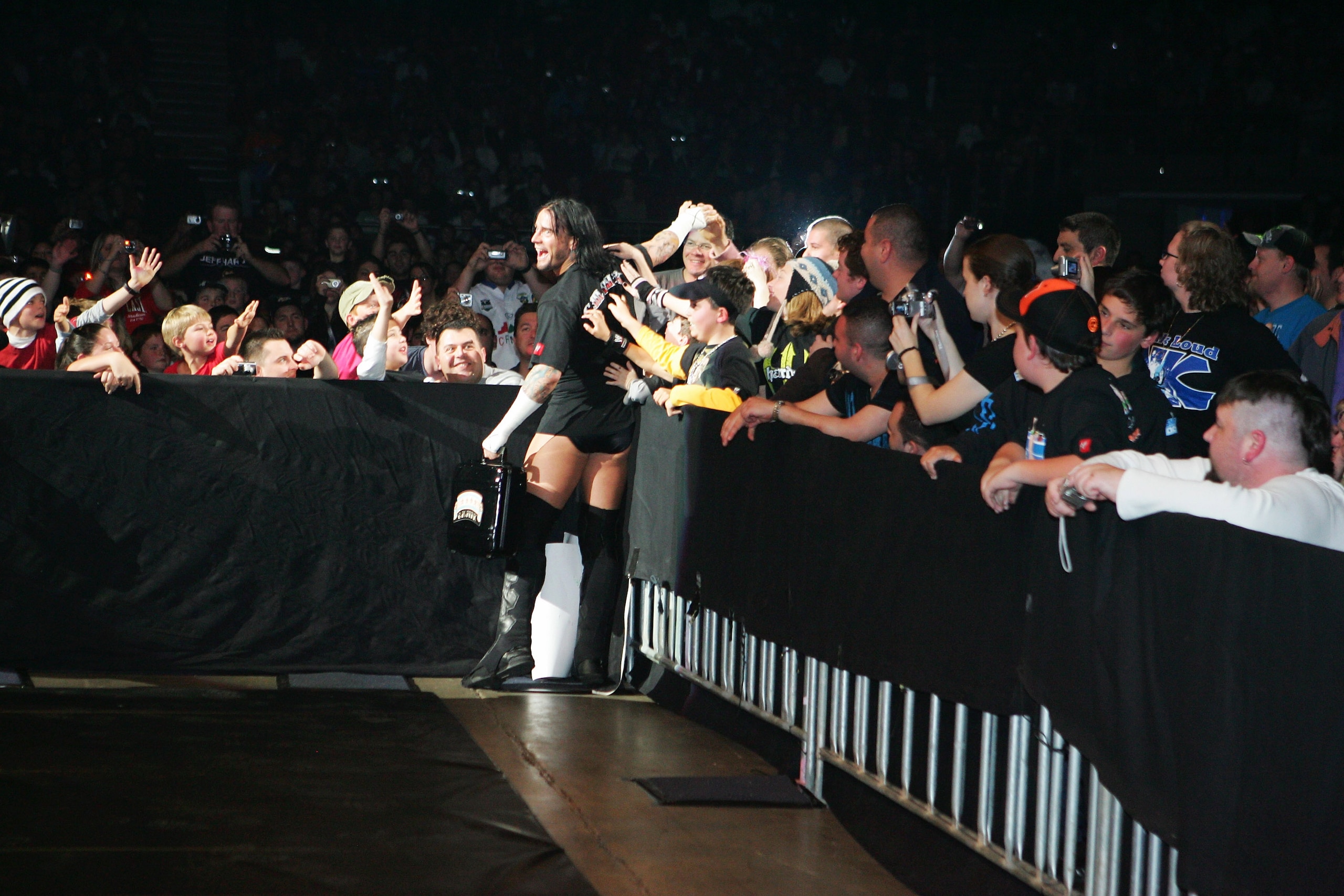 SYDNEY, AUSTRALIA - JUNE 15:  CM Punk celebrates with fans before facing Shelton Benjamin during WWE Smackdown at Acer Arena on June 15, 2008 in Sydney, Australia.  (Photo by Gaye Gerard/Getty Images)