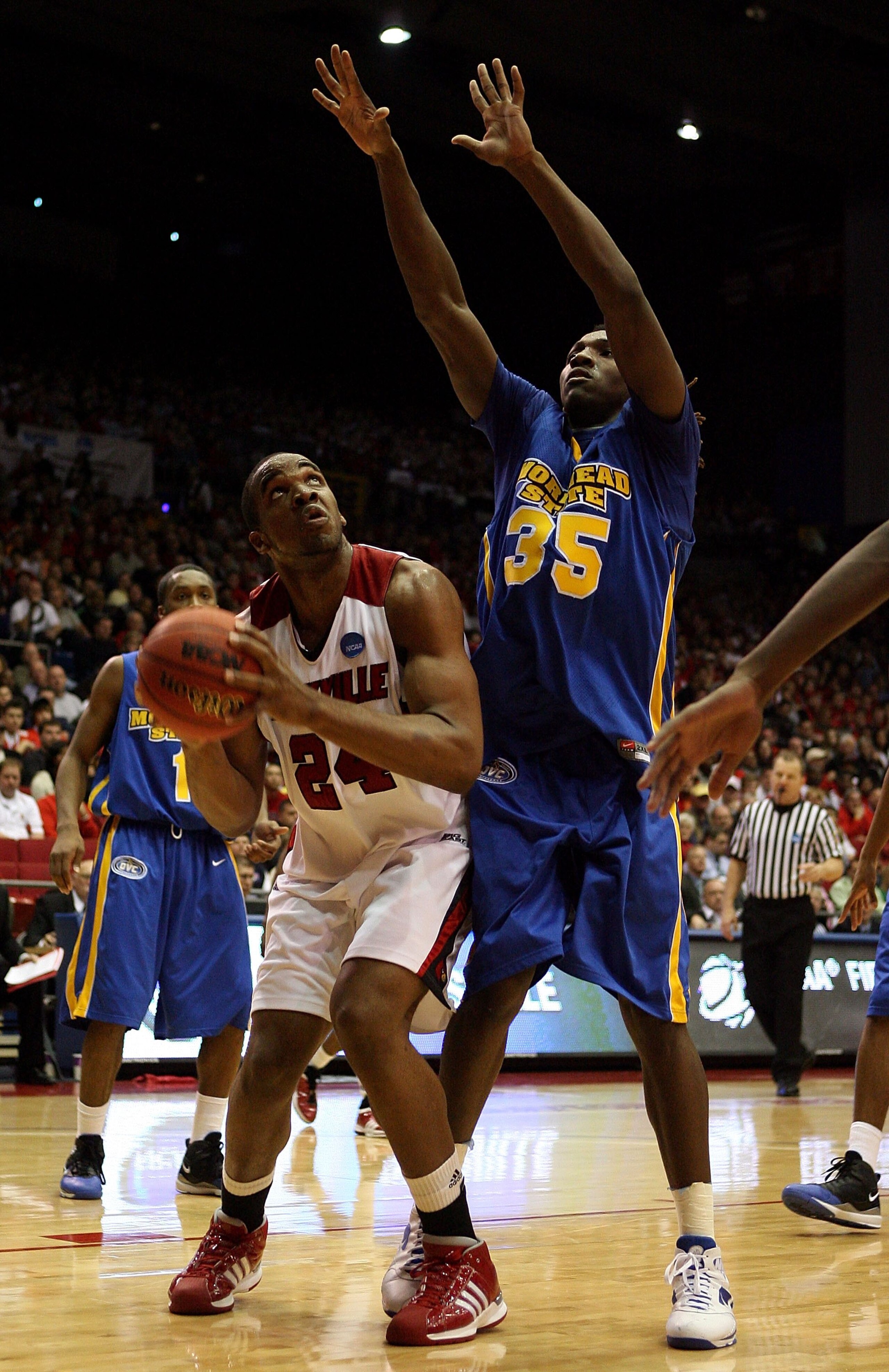 DAYTON, OH - MARCH 20: Samardo Samuels #24 of the Louisville Cardinals drives to the hoop against Kenneth Faried #35 of the Morehead State Eagles during the first round of the NCAA Division I Men's Basketball Tournament at the University of Dayton Arena o DAYTON, OH - MARCH 20: Samardo Samuels #24 of the Louisville Cardinals drives to the hoop against Kenneth Faried #35 of the Morehead State Eagles during the first round of the NCAA Division I Men's Basketball Tournament at the University of Dayton Arena o