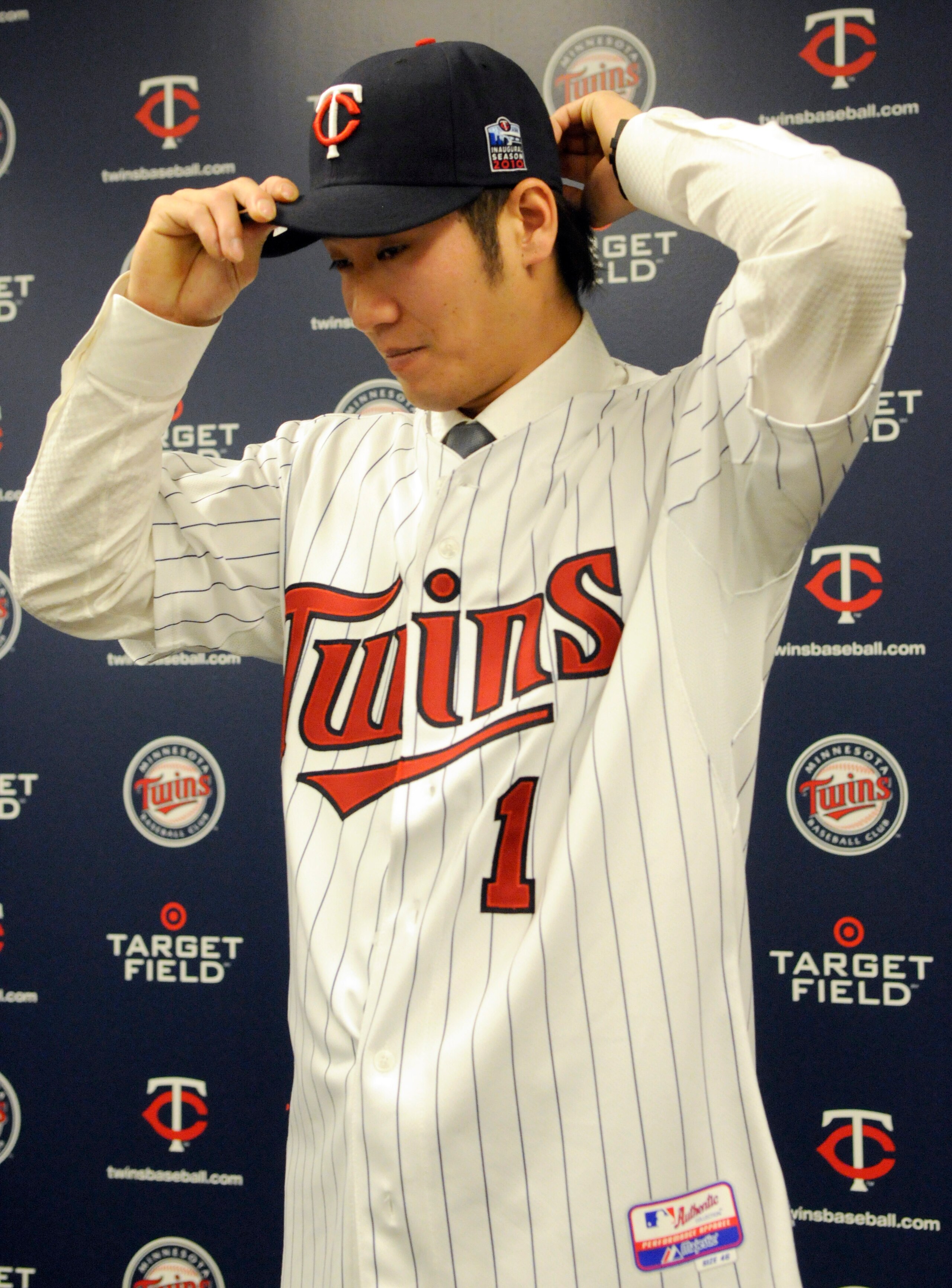 MINNEAPOLIS, MN - DECEMBER 18: Tsuyoshi Nishioka #1 of the Minnesota Twins puts on his Twins hats for members of the media during a press conference on December 18, 2010 at Target Field in Minneapolis, Minnesota. (Photo by Hannah Foslien /Getty Images)