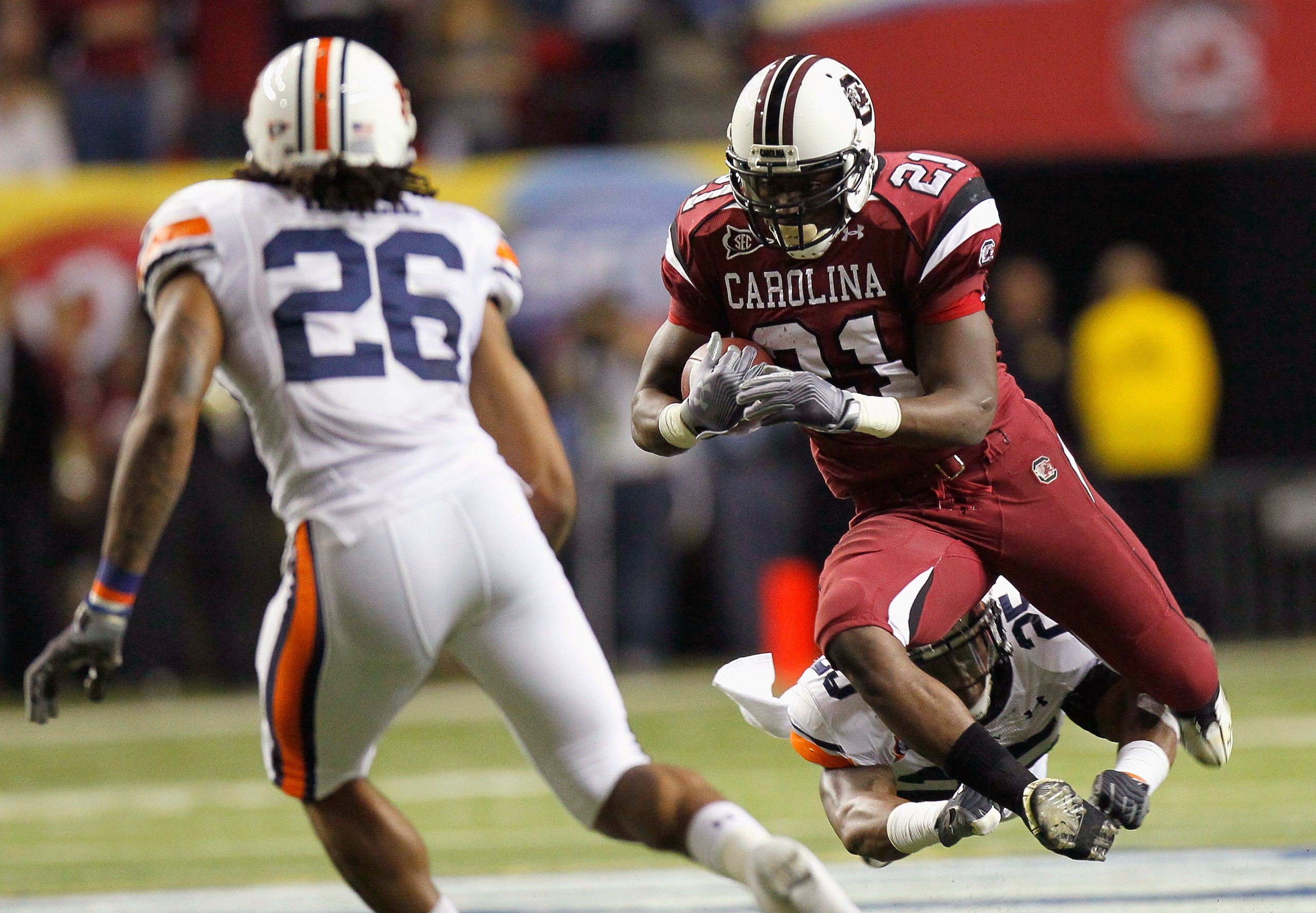 ATLANTA, GA - DECEMBER 04: Marcus Lattimore #21 of the South Carolina Gamecocks is tackled by Daren Bates #25 of the Auburn Tigers during the 2010 SEC Championship at Georgia Dome on December 4, 2010 in Atlanta, Georgia. (Photo by Kevin C. Cox/Getty Ima ATLANTA, GA - DECEMBER 04: Marcus Lattimore #21 of the South Carolina Gamecocks is tackled by Daren Bates #25 of the Auburn Tigers during the 2010 SEC Championship at Georgia Dome on December 4, 2010 in Atlanta, Georgia. (Photo by Kevin C. Cox/Getty Ima