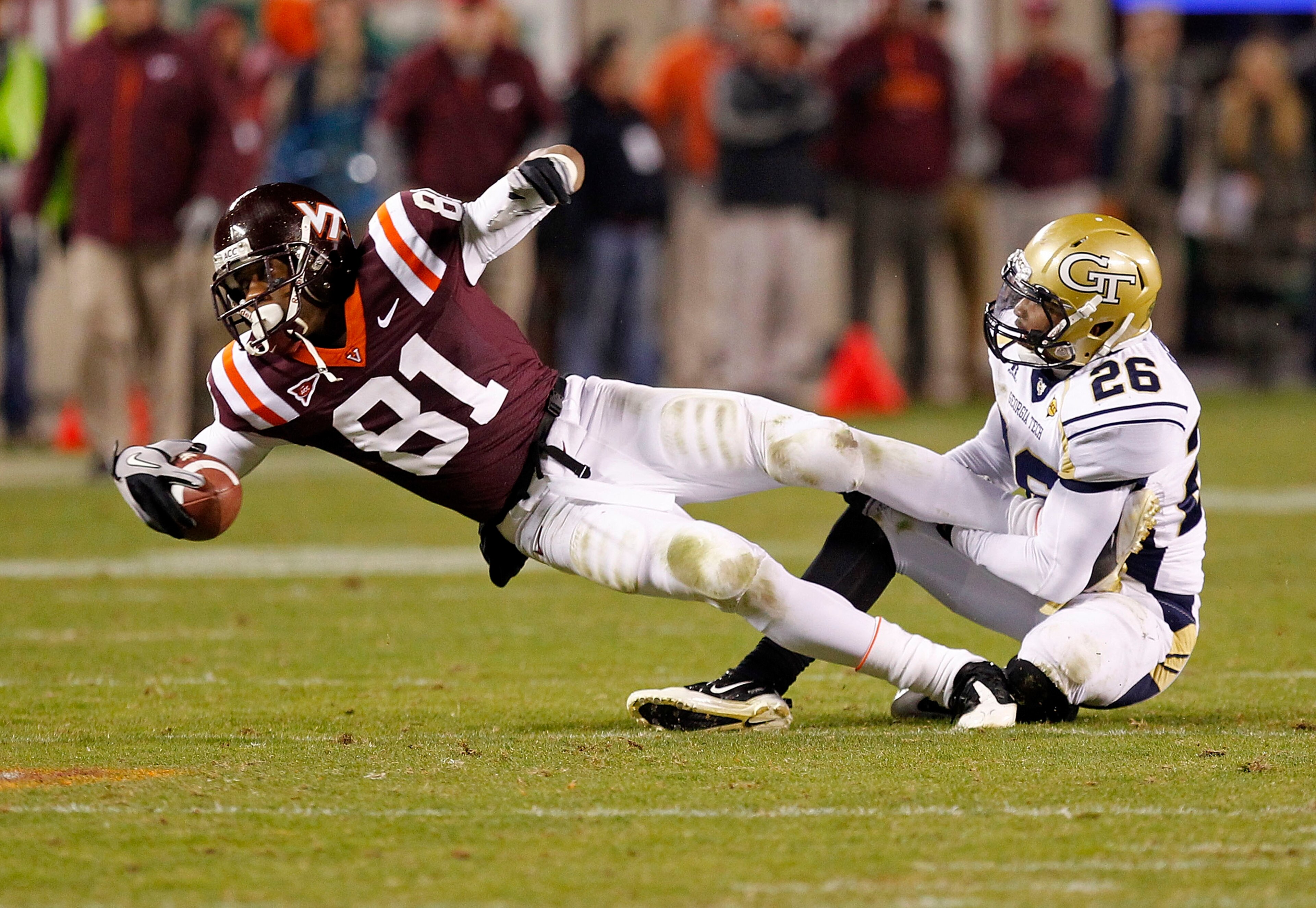 BLACKSBURG, VA - NOVEMBER 04: Wide receiver Jarrett Boykin #81 of the Virginia Tech Hokies dives after catching the ball as cornerback Dominique Reese #26 of the Georgia Tech Yellow Jackets makes the tackle at Lane Stadium on November 4, 2010 in Blacksbur