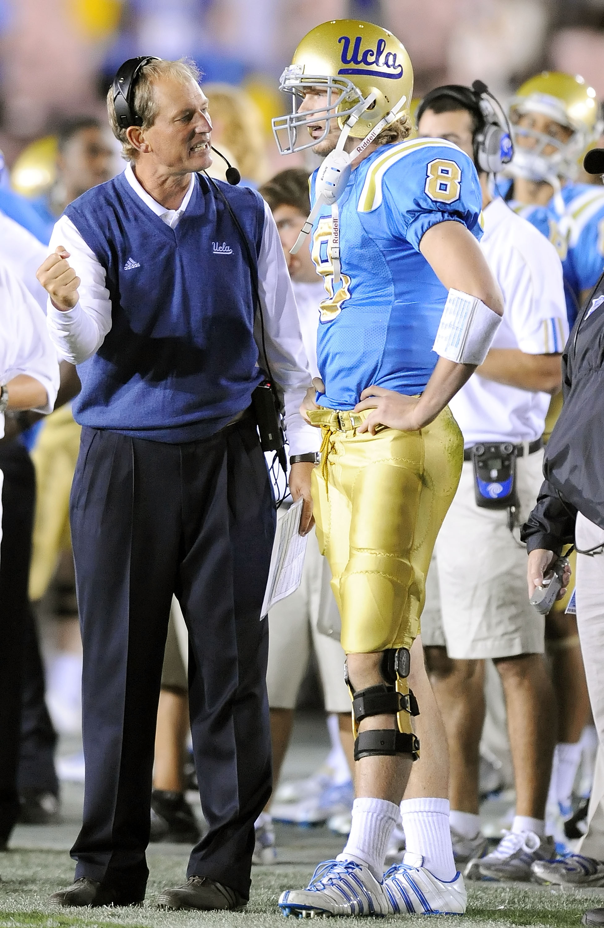 PASADENA, CA - NOVEMBER 08:  Head coach Rick Neuheisel talks with Chris Forcier #8 of the UCLA Bruins during the game against the Oregon State Beavers at the Pasadena Rose Bowl on November 8, 2008 in Pasadena, California.  (Photo by Lisa Blumenfeld/Getty