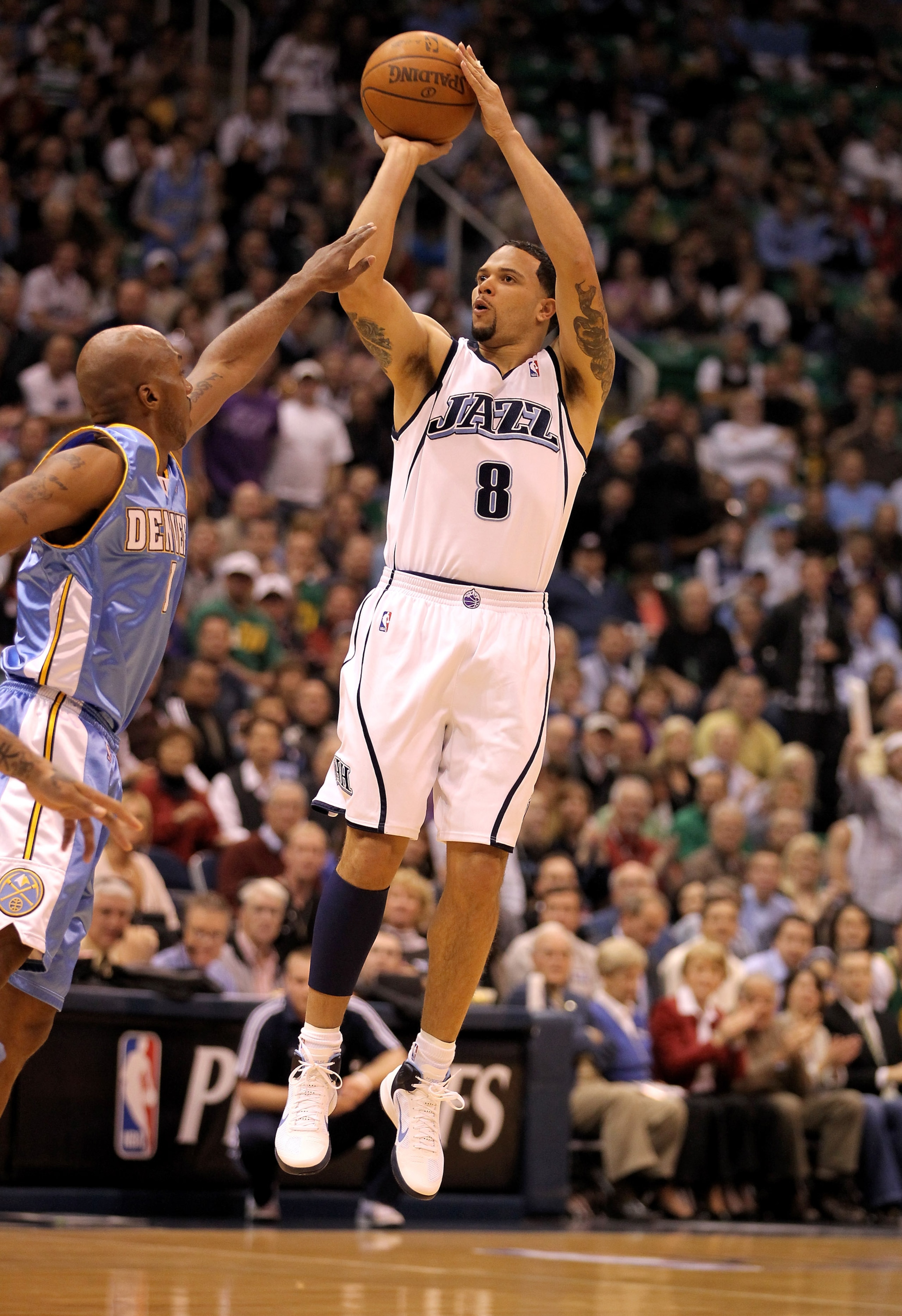 SALT LAKE CITY - APRIL 30:  Deron Williams #8 of the Utah Jazz shoots over Chauncey Billups #1 of the Denver Nuggets during Game Six of the Western Conference Quarterfinals of the 2010 NBA Playoffs at EnergySolutions Arena on April 30, 2010 in Salt Lake C